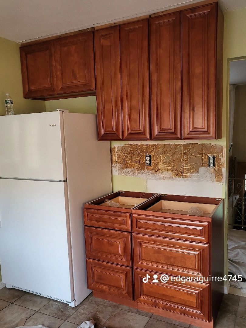 a kitchen with wooden cabinets and a white refrigerator