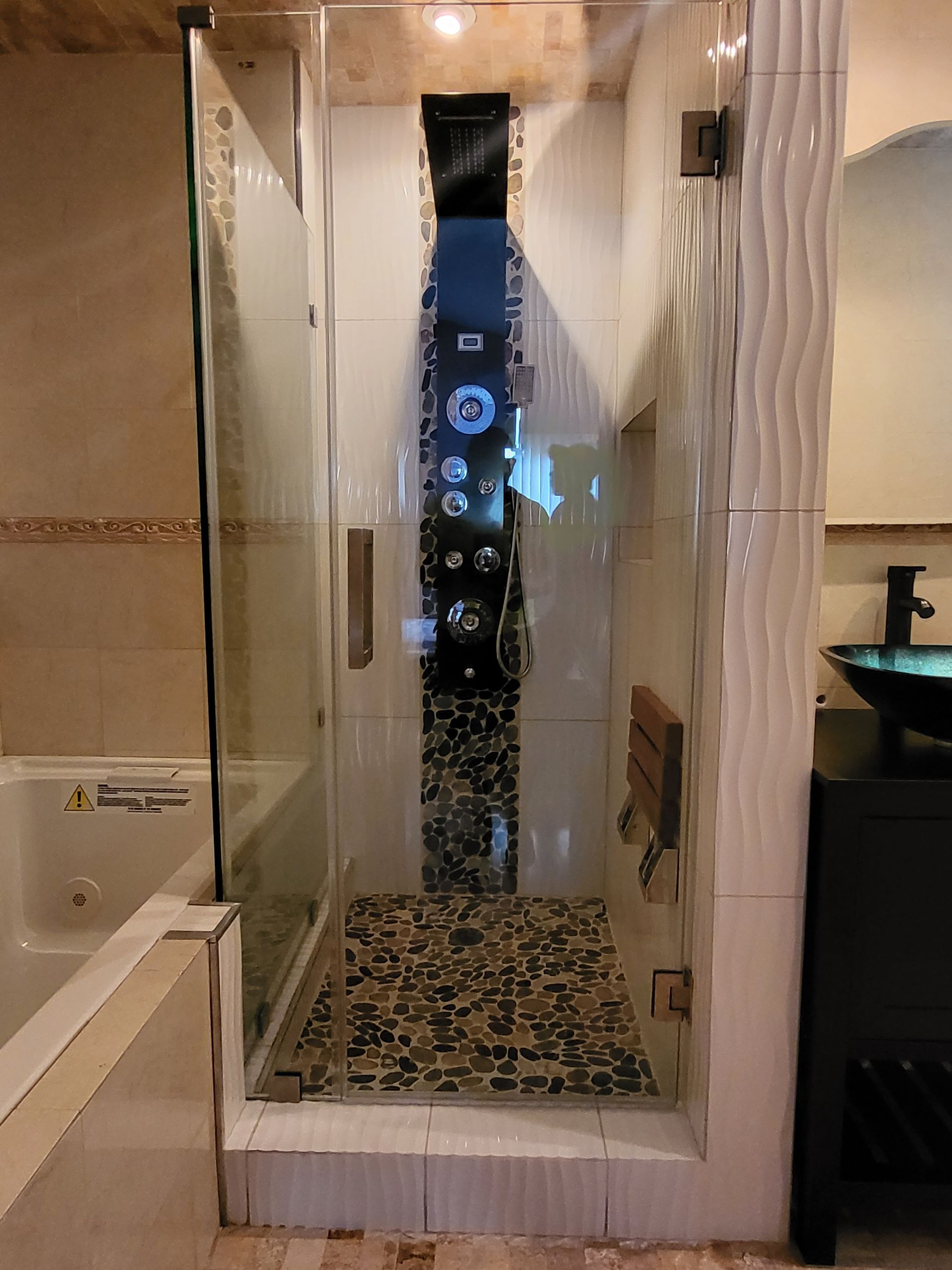 a bathroom with a walk-in shower and a sink