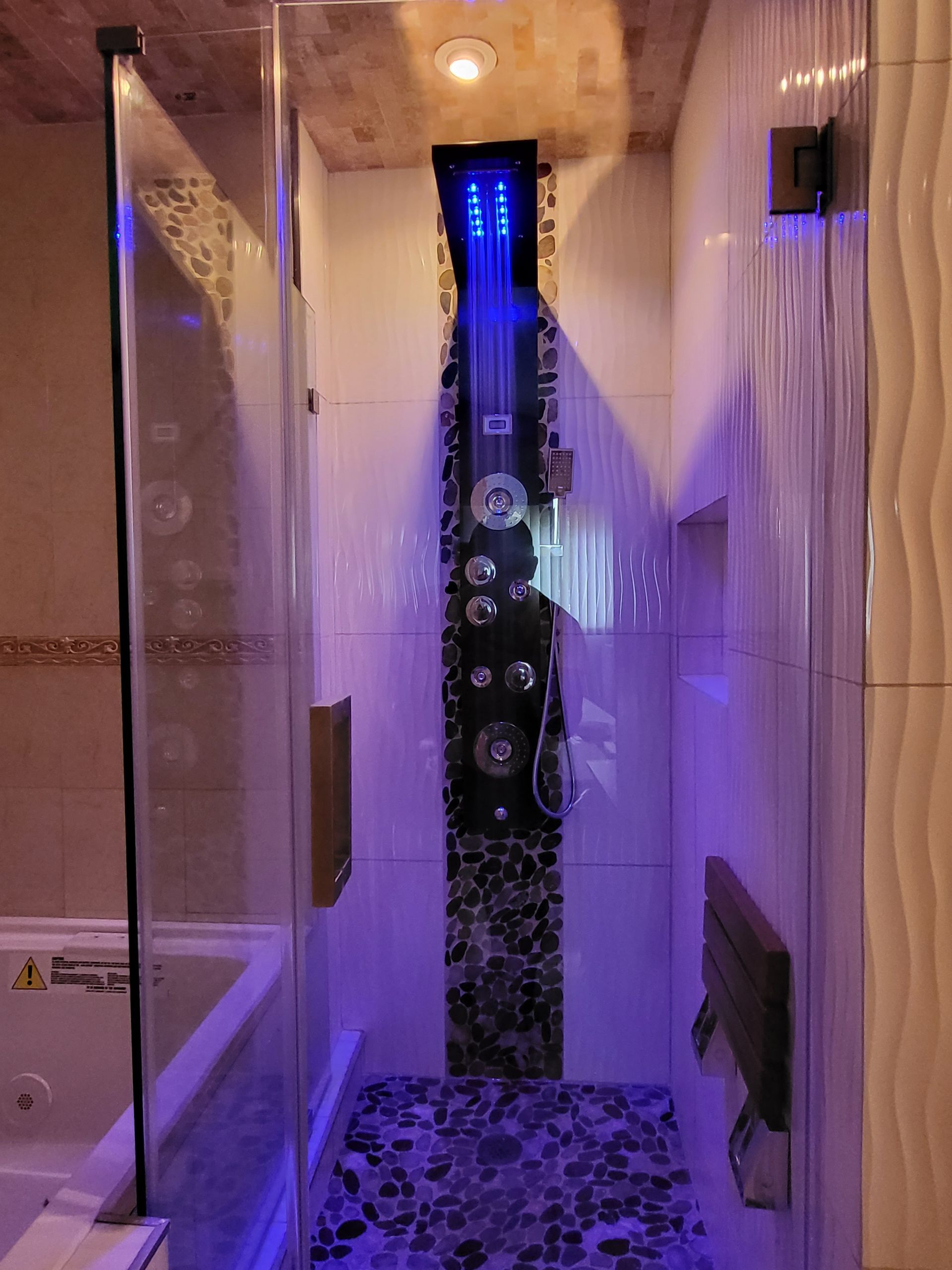 a bathroom with a walk-in shower and a bathtub