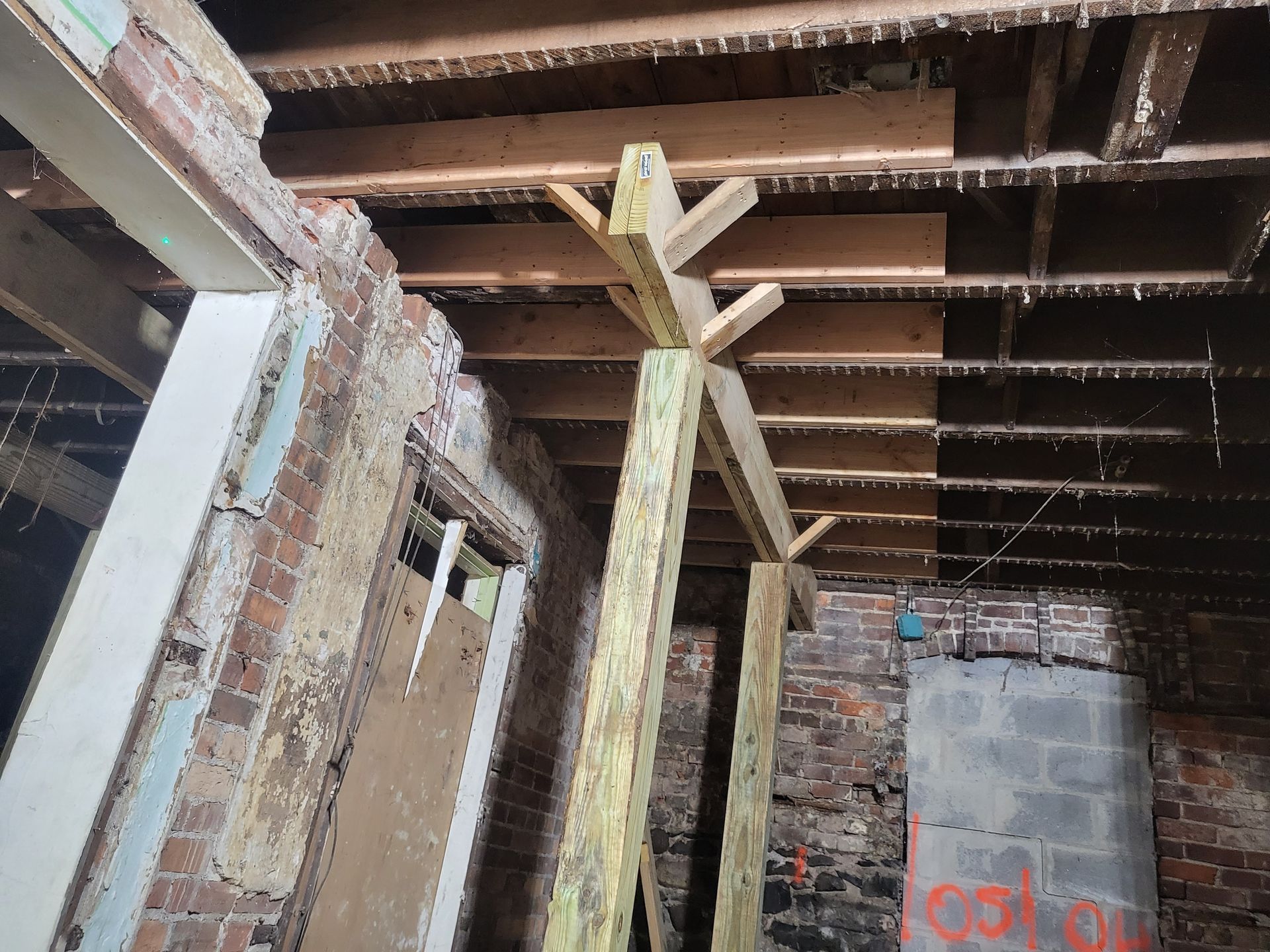 a room with a brick wall and wooden beams