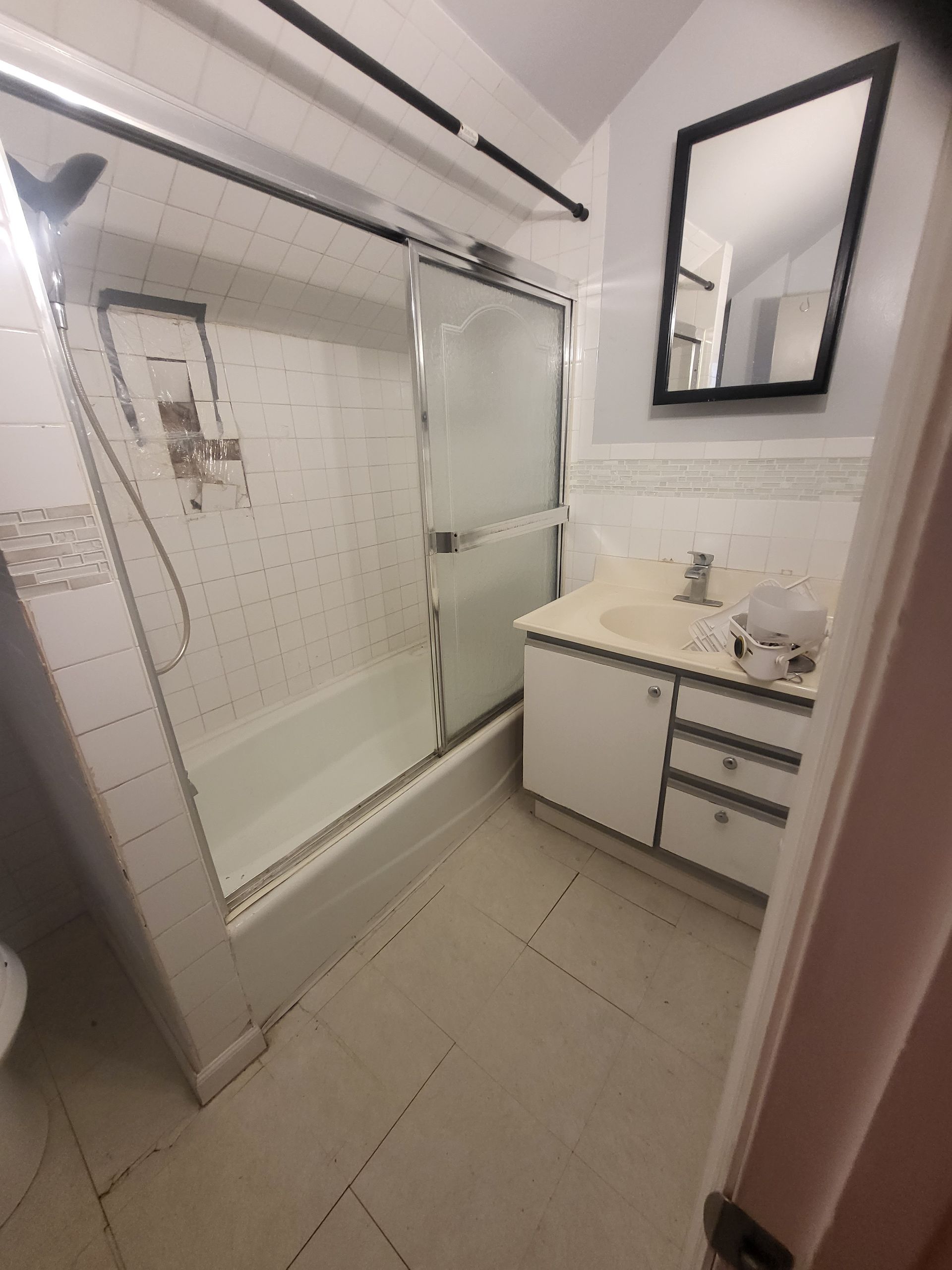 a bathroom with a bathtub a sink and a mirror