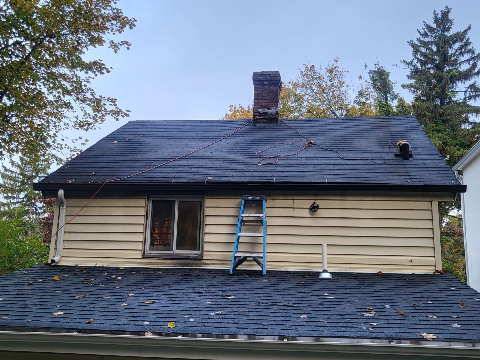 a ladder is sitting on the roof of a house