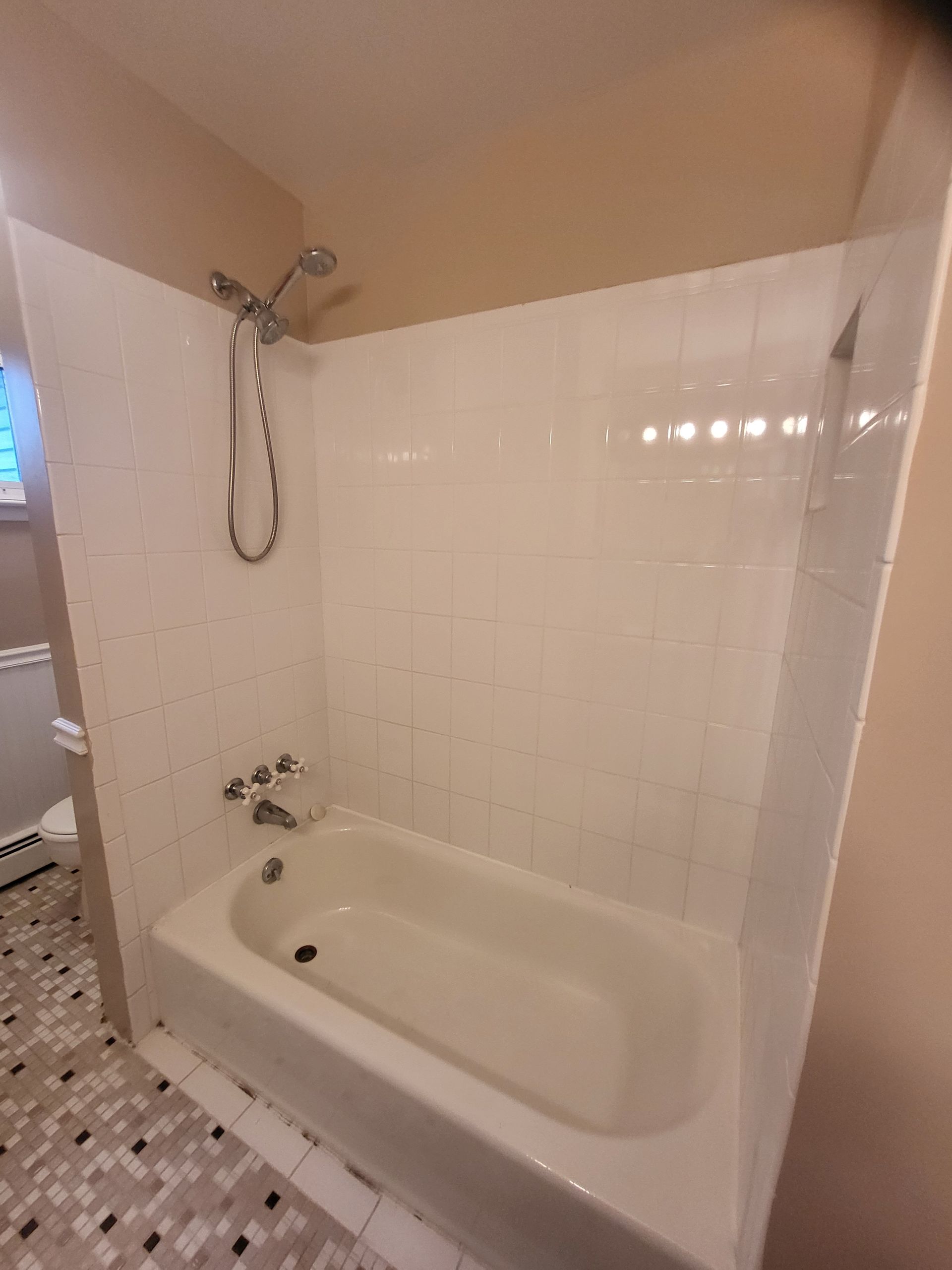 a bathroom with a bathtub and a shower