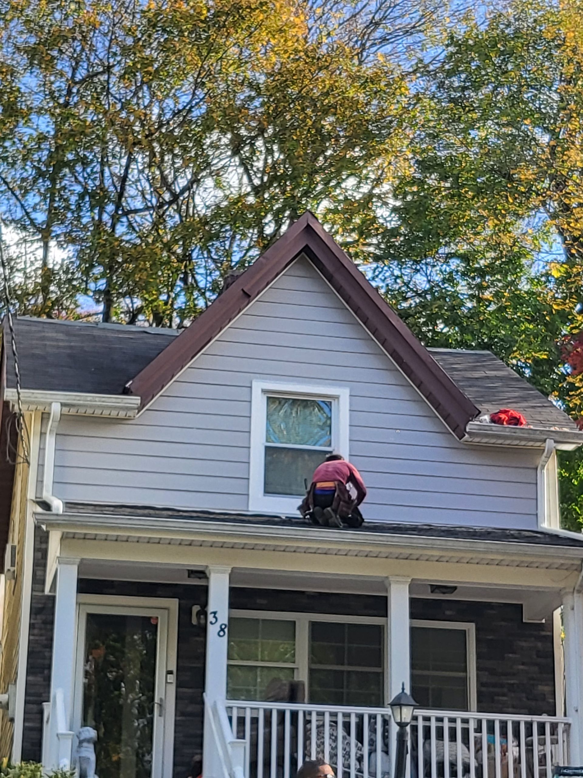 a man is working on the roof of a house