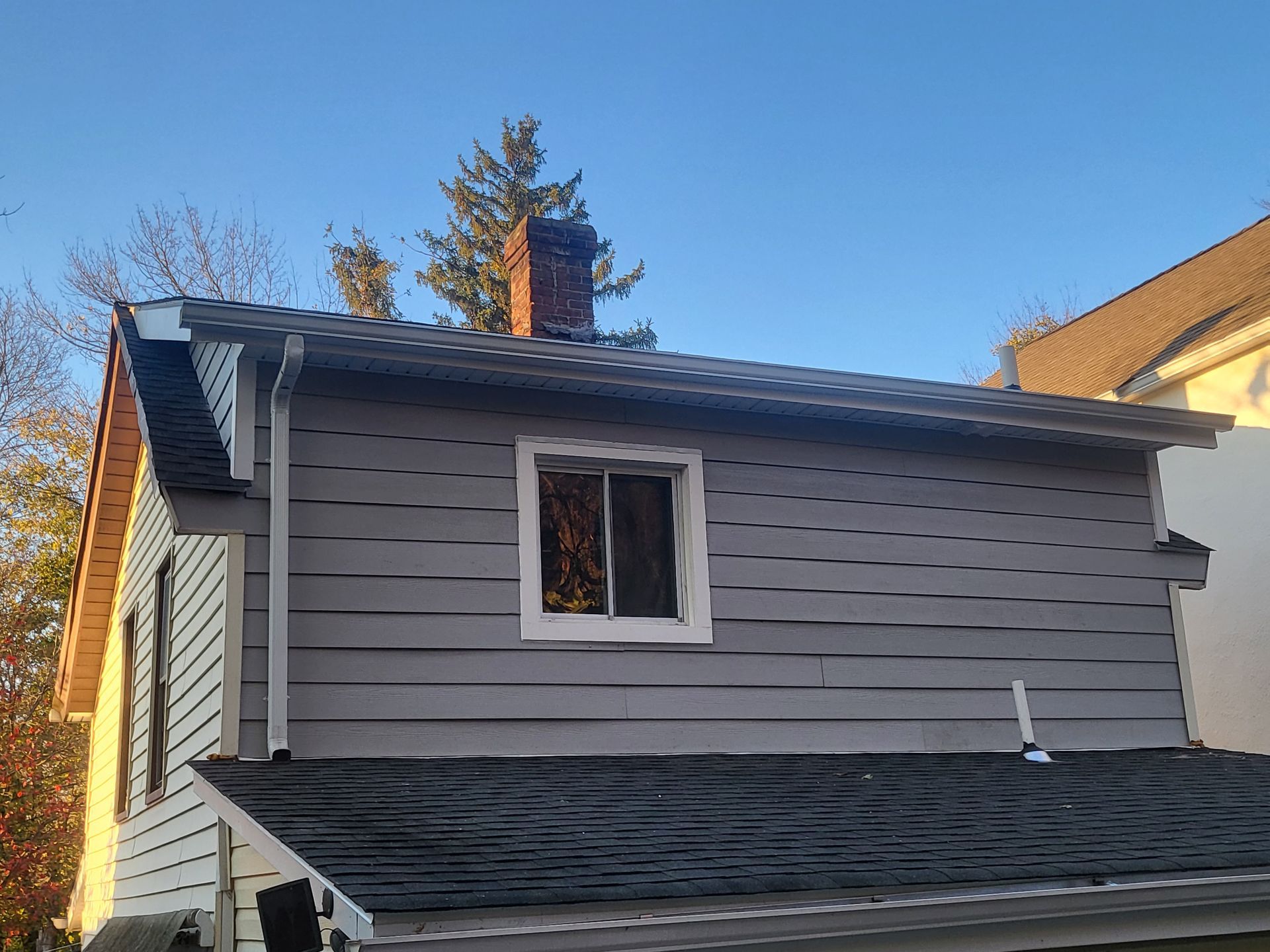 a house with a chimney on the roof and a window