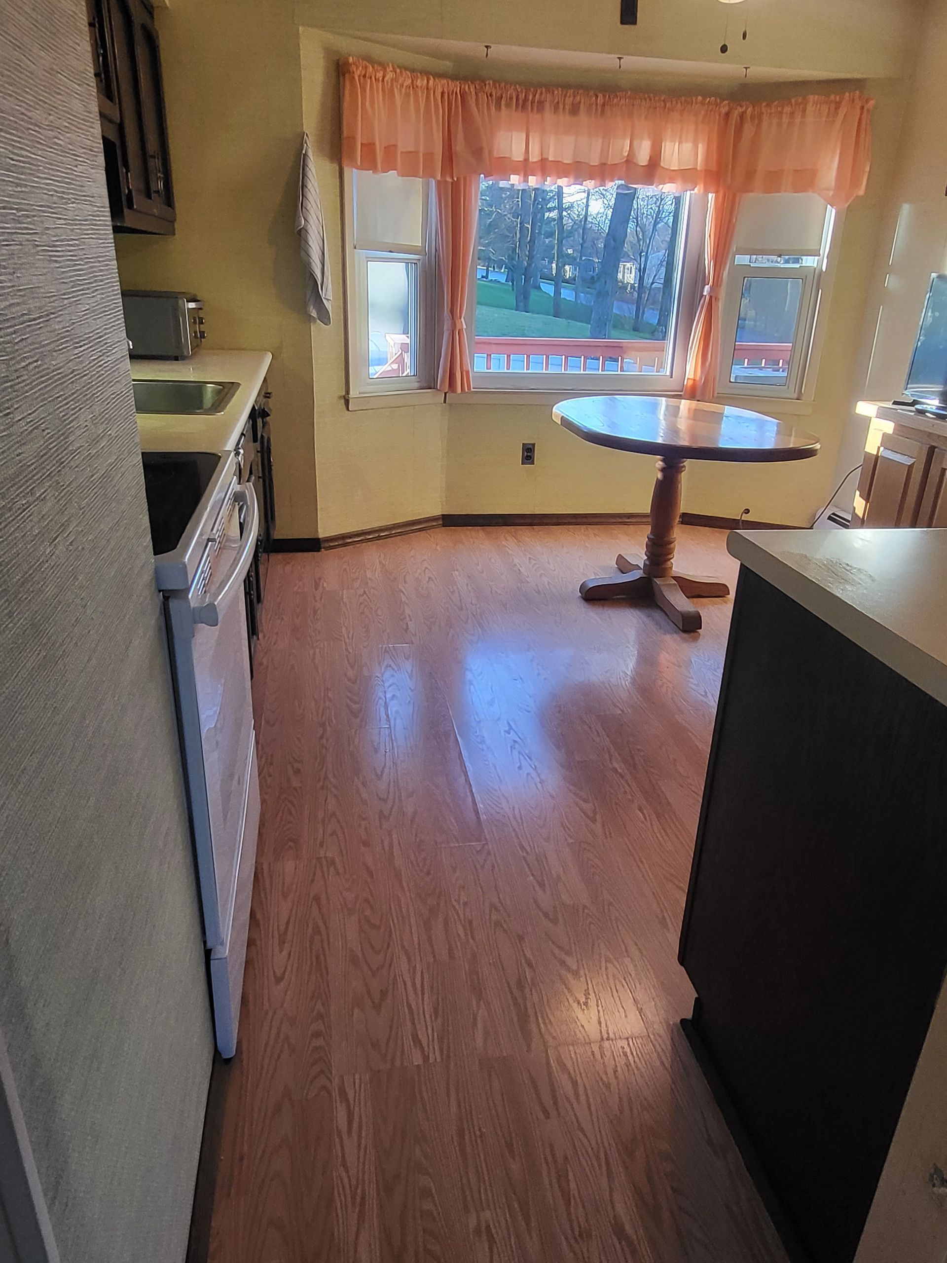 a kitchen with a table and a large window