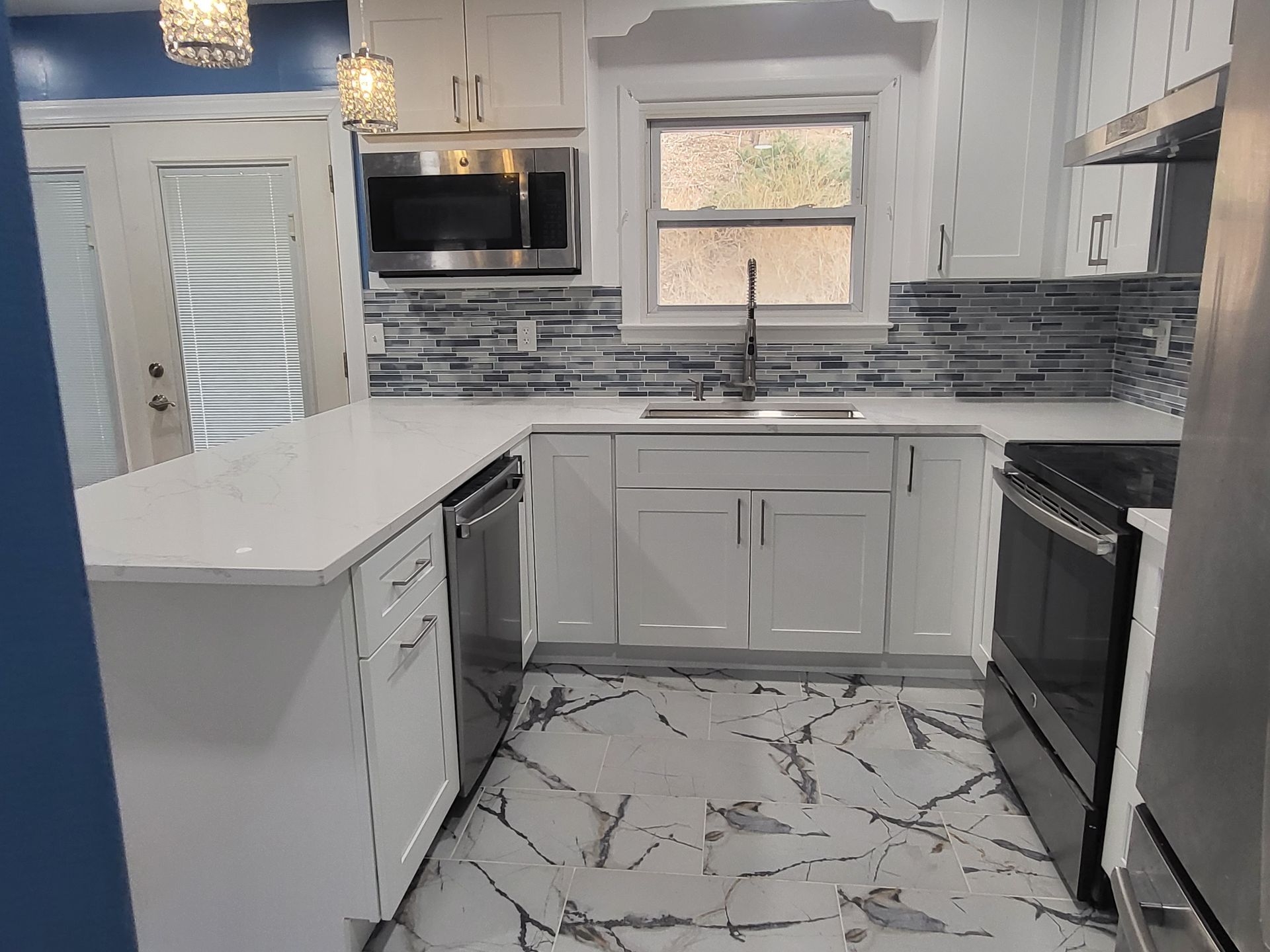 a kitchen with white cabinets and stainless steel appliances