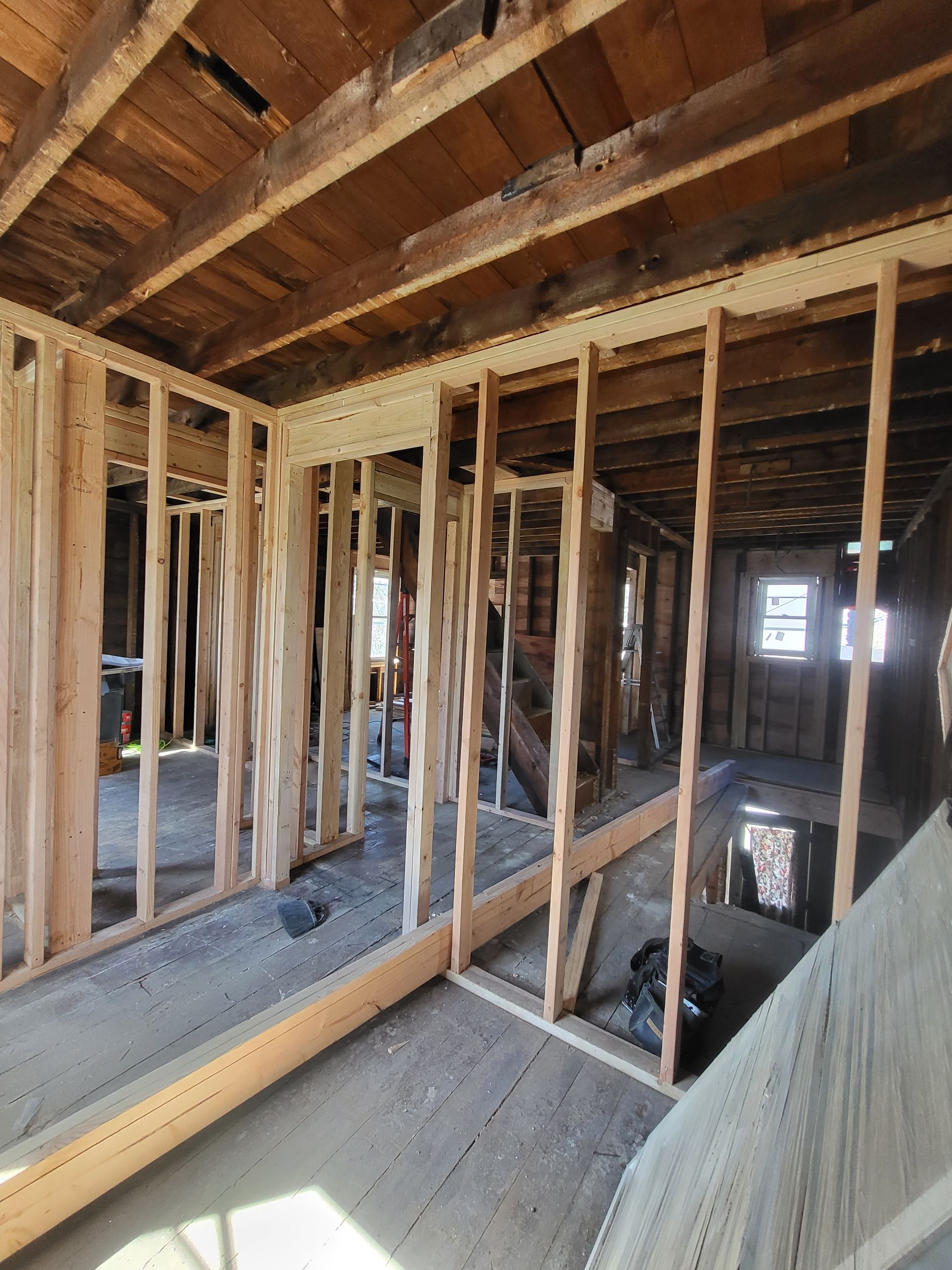 the inside of a house under construction with wooden beams