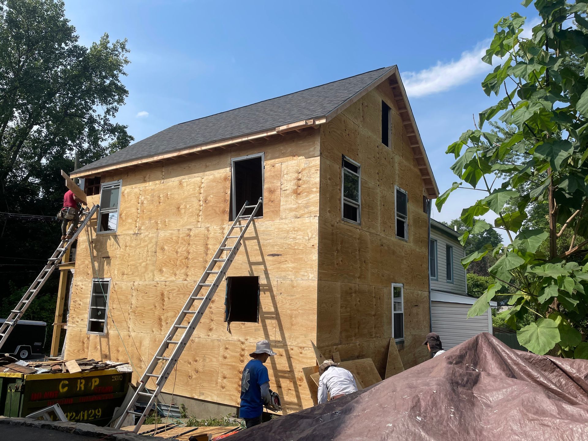 a house that is being built with plywood on it