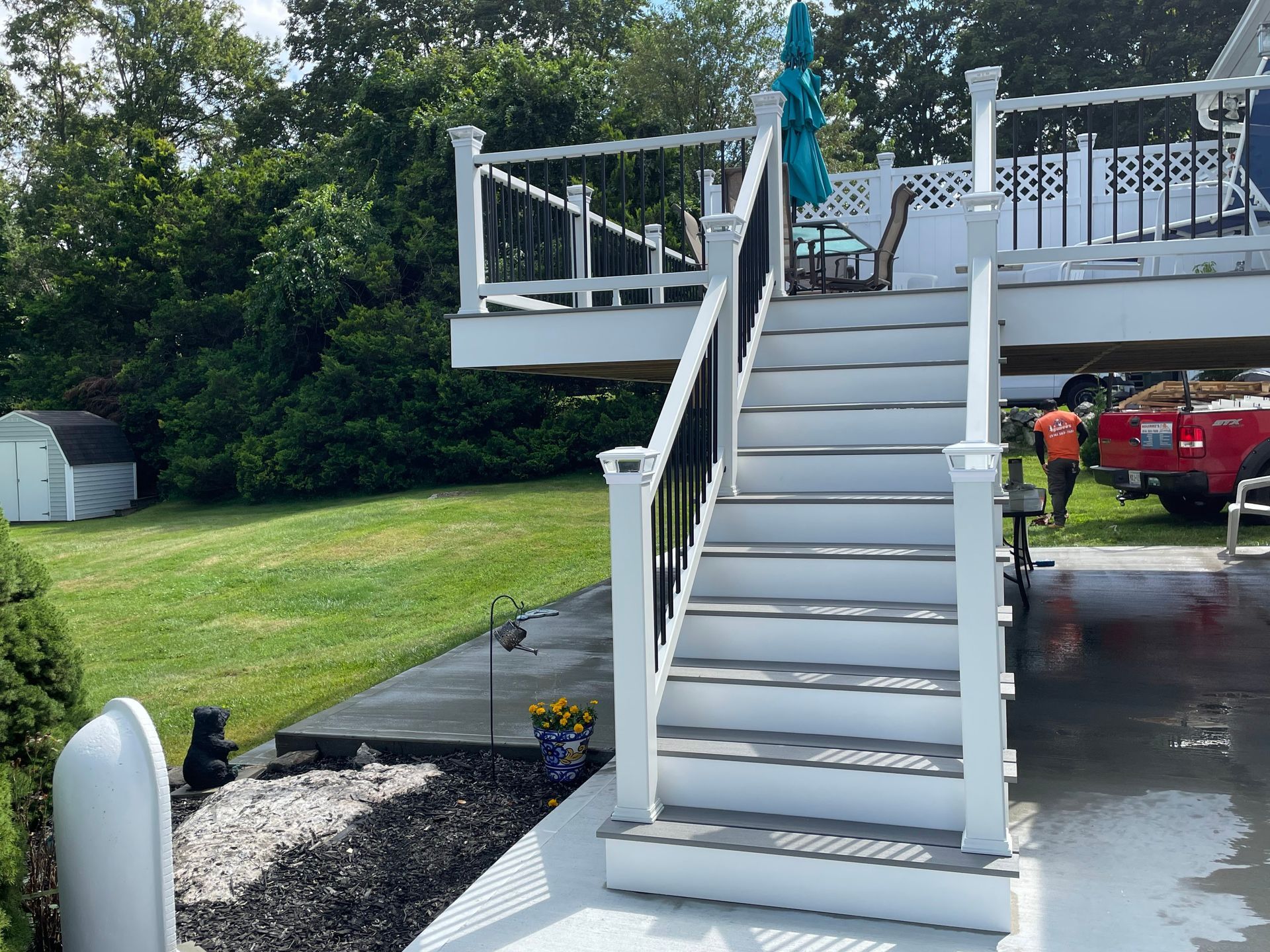 a white deck with stairs leading up to it