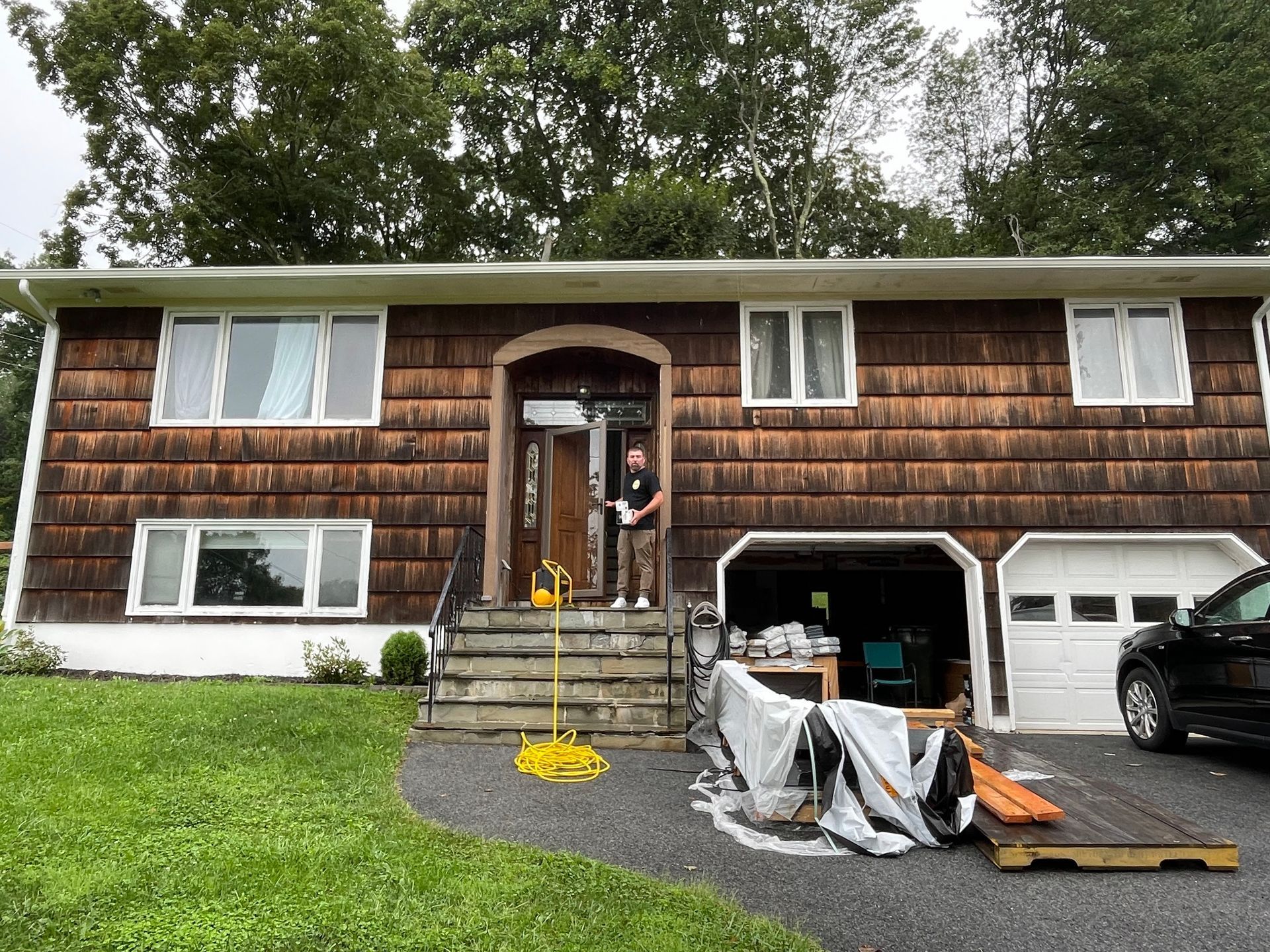 a man is standing in front of a house that is being painted