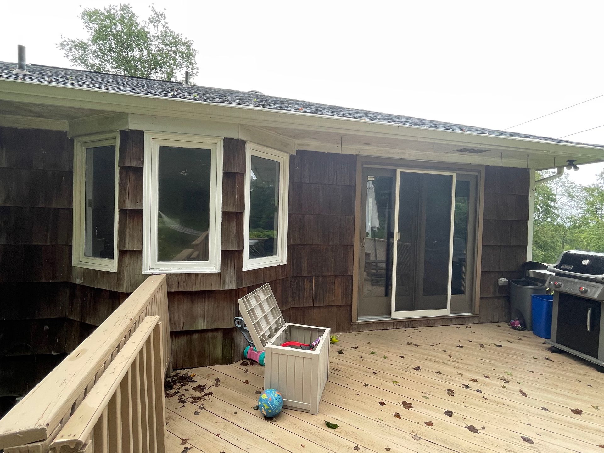 a house with a large deck and a grill on it