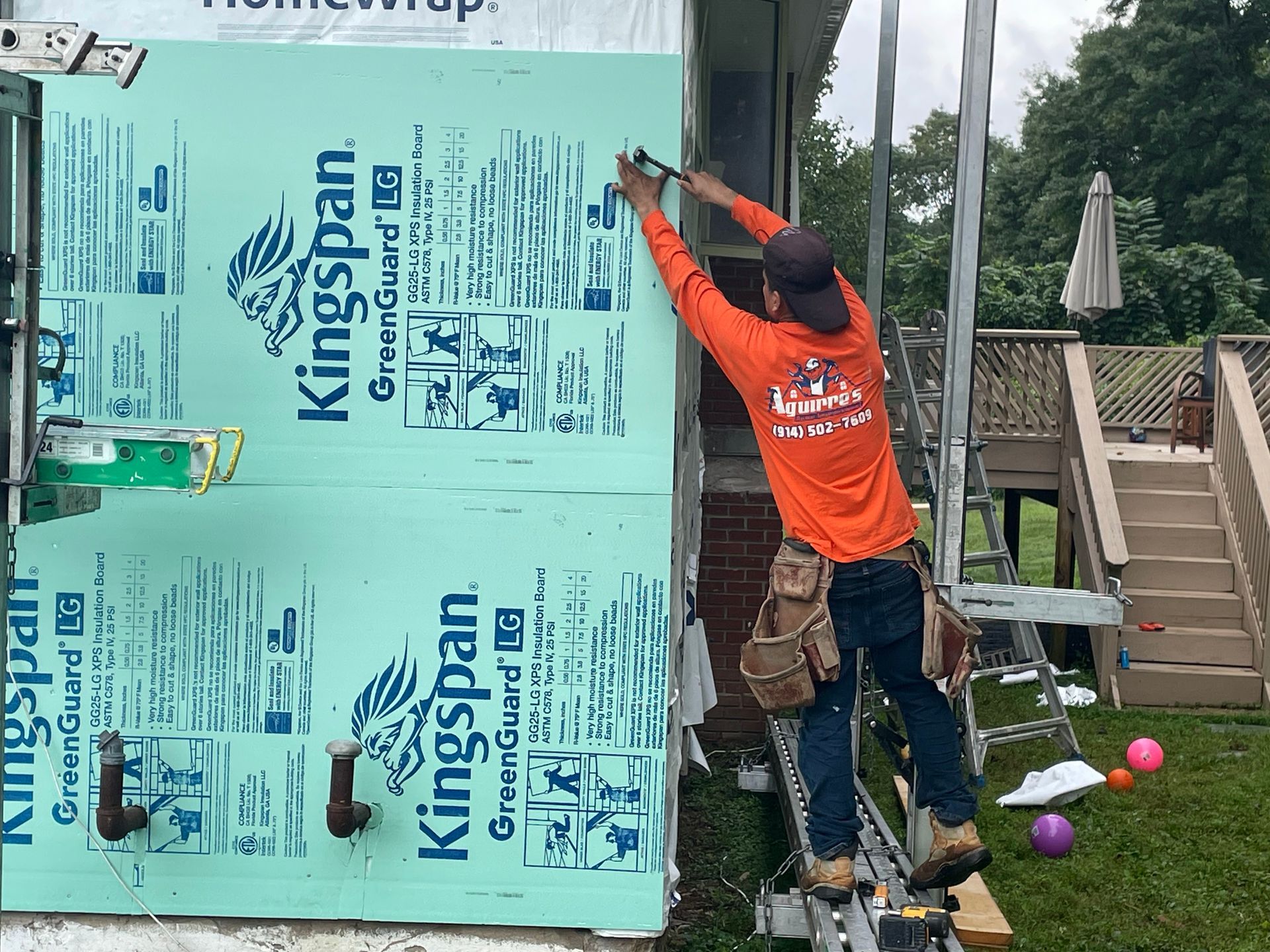 a man is working on a house with Kingspan insulation