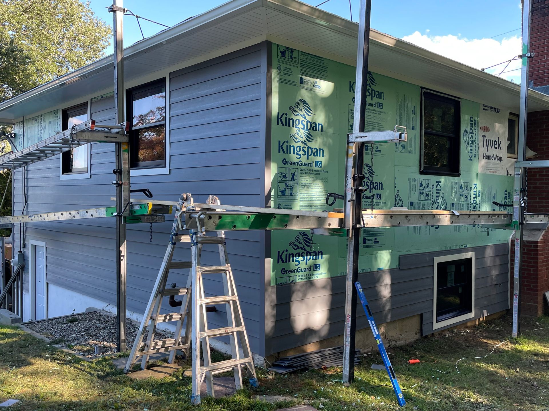 a house is being remodeled with a ladder in front of it