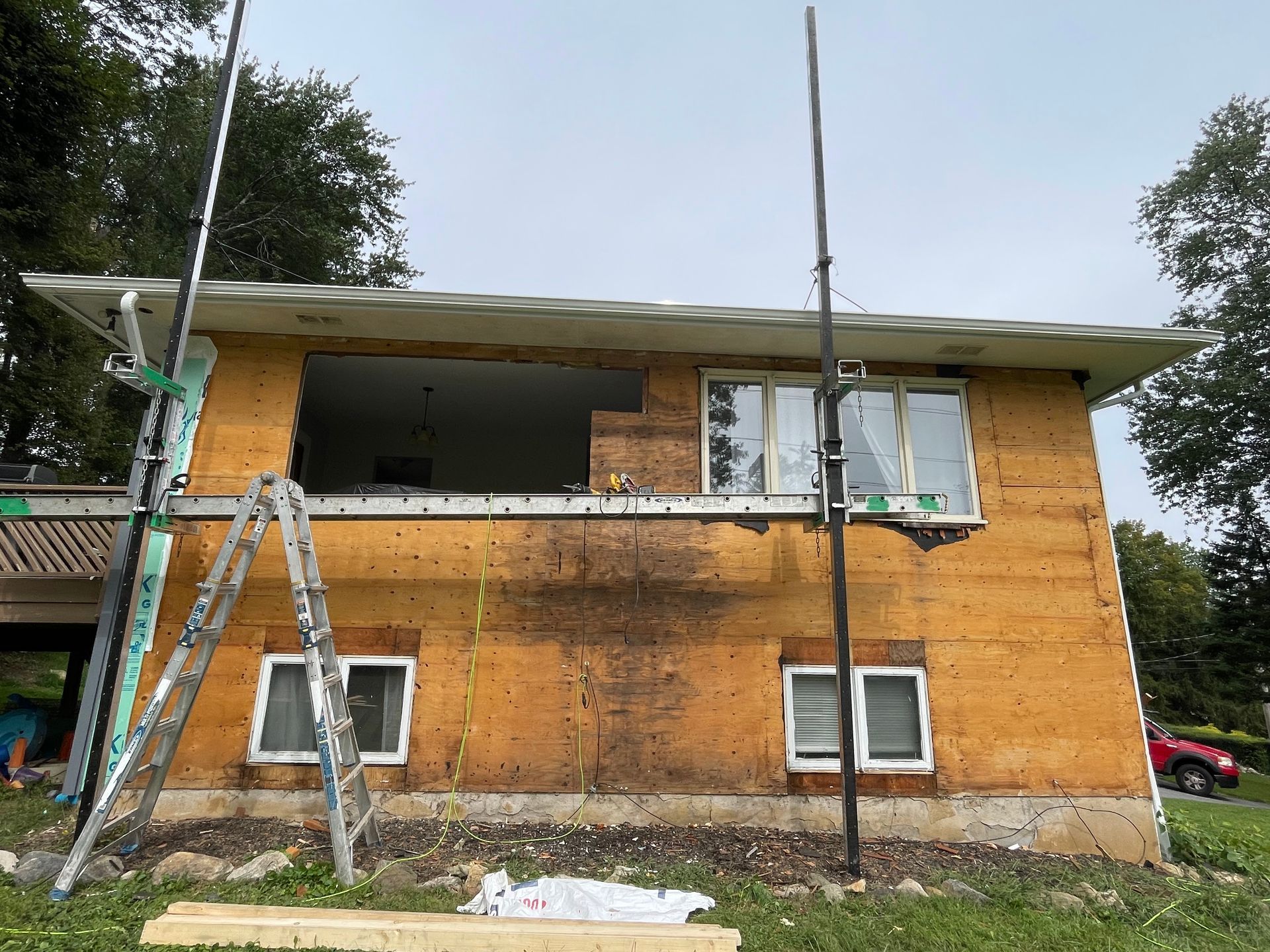 a house with a ladder sitting on the side of it