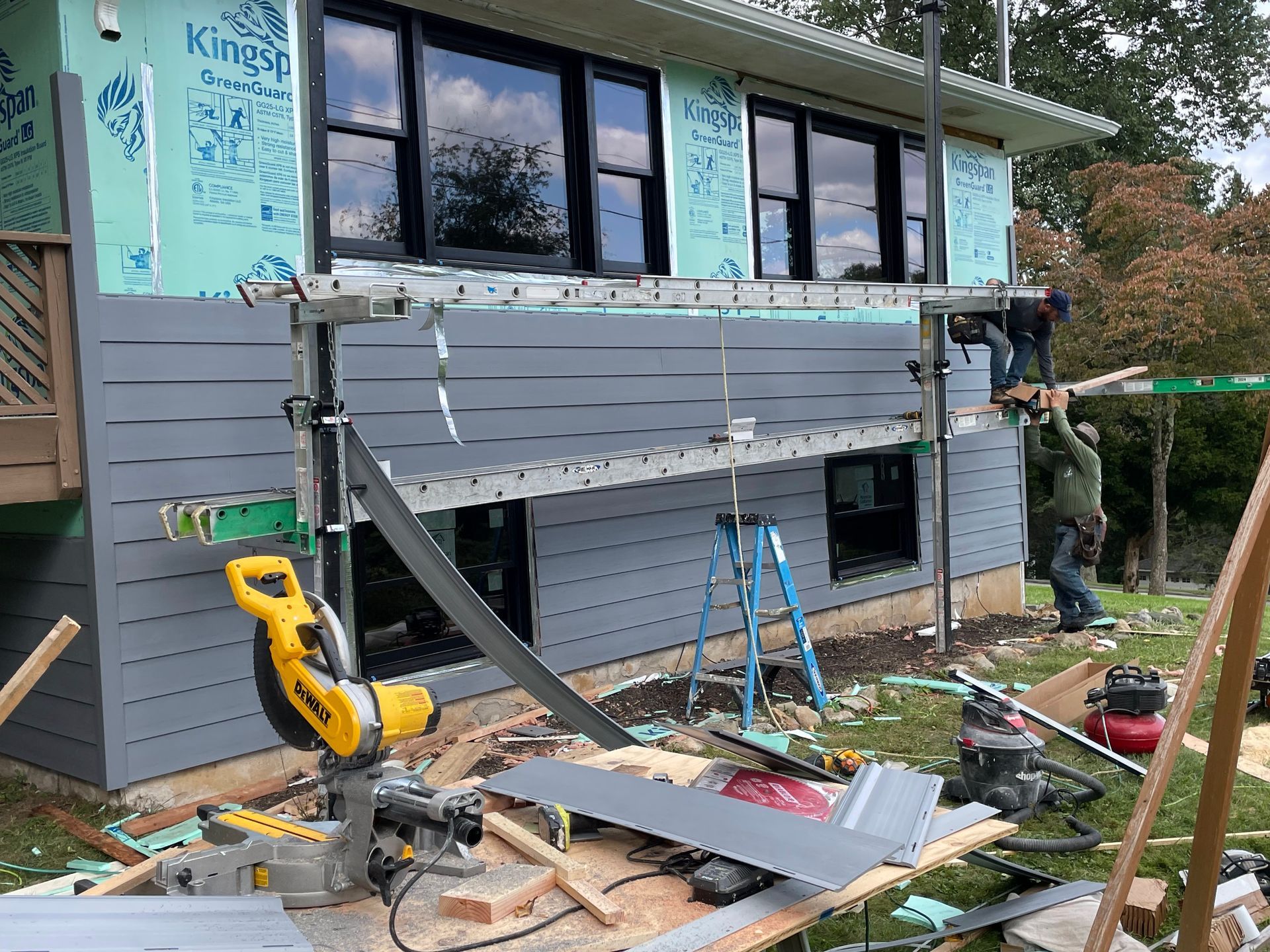 a house is being remodeled and a circular saw is sitting in front of it