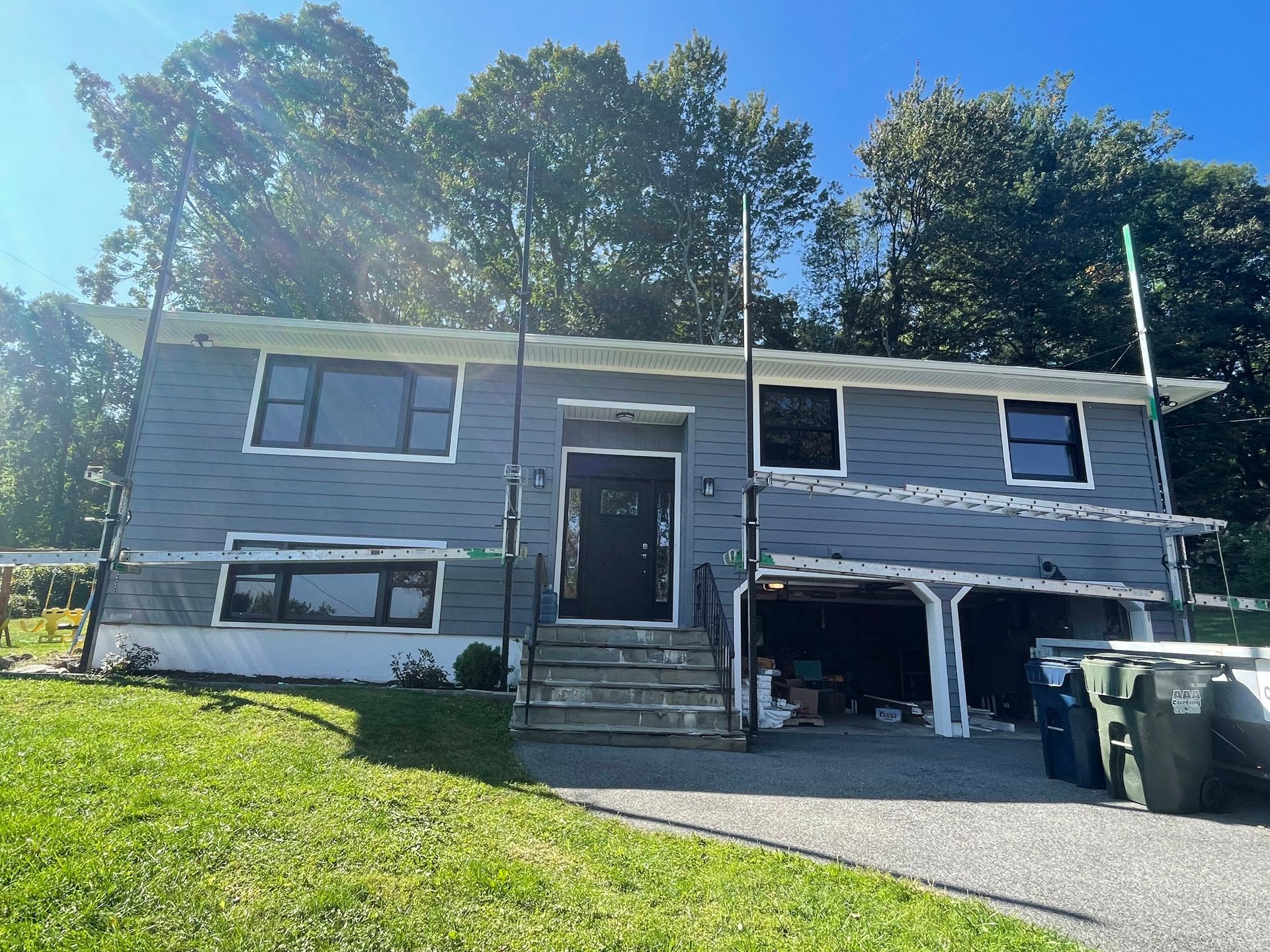 a house with a garage and a lot of windows is for sale