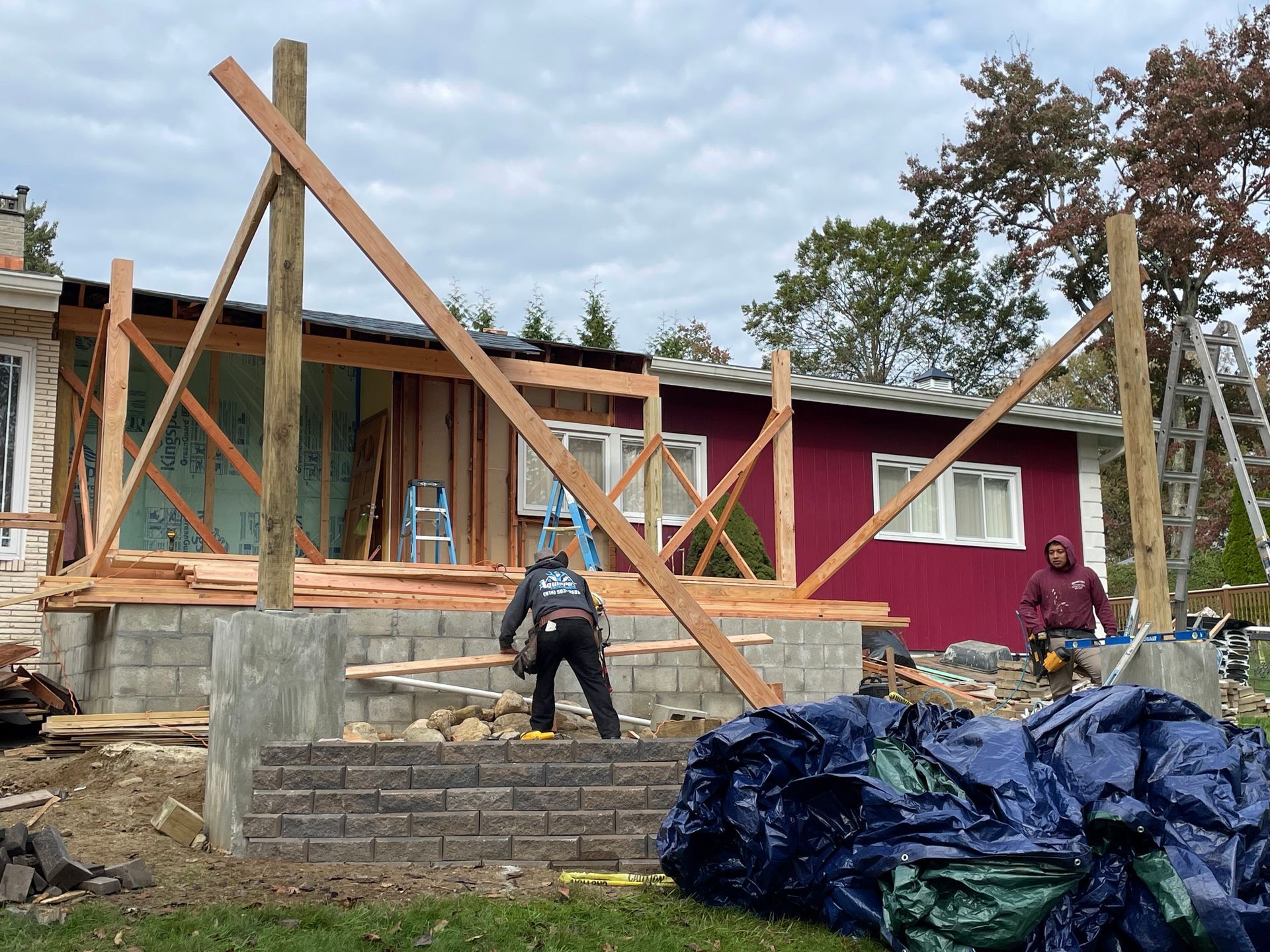 a man is standing in front of a house under construction