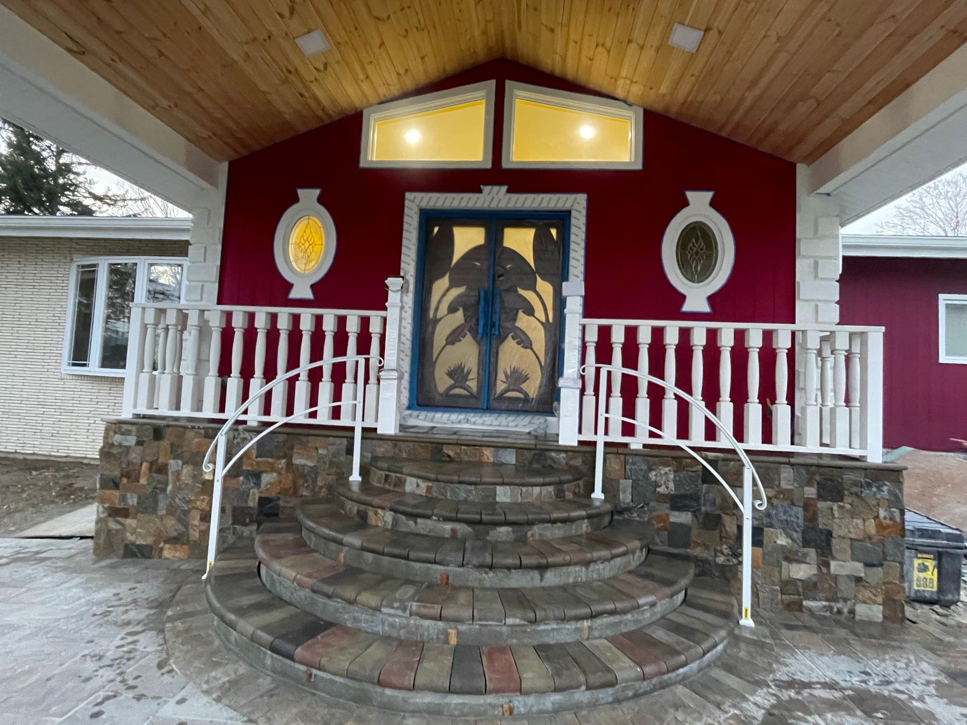 a red house with a blue door and stone steps