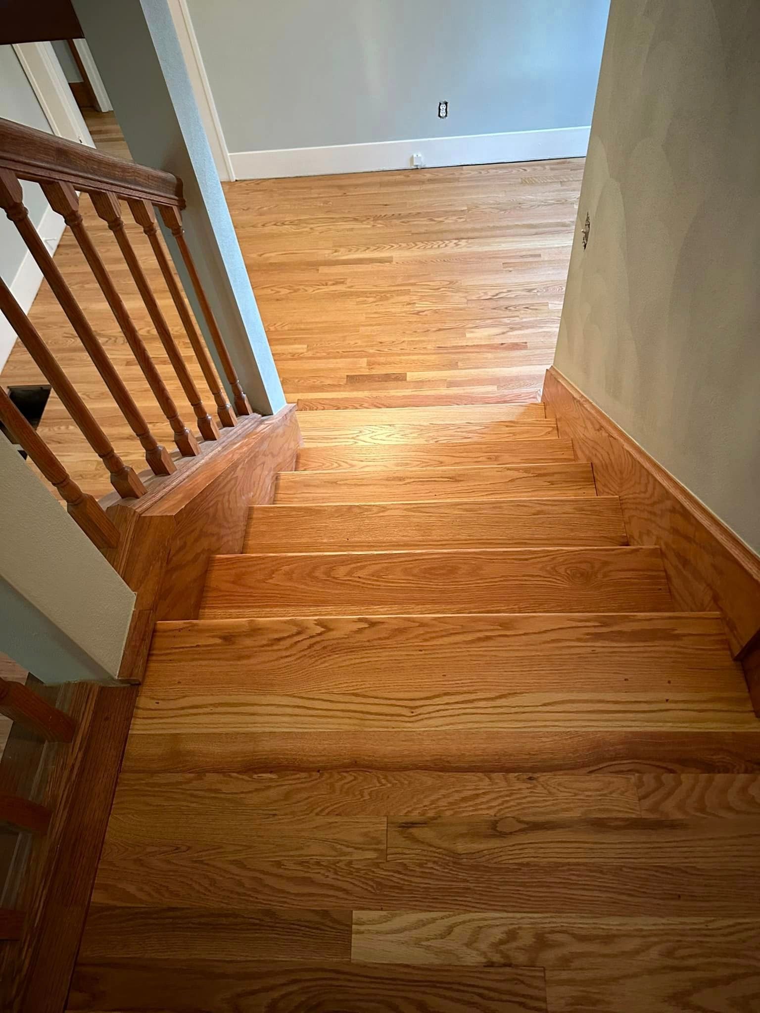 A set of wooden stairs leading up to a second floor in a house.