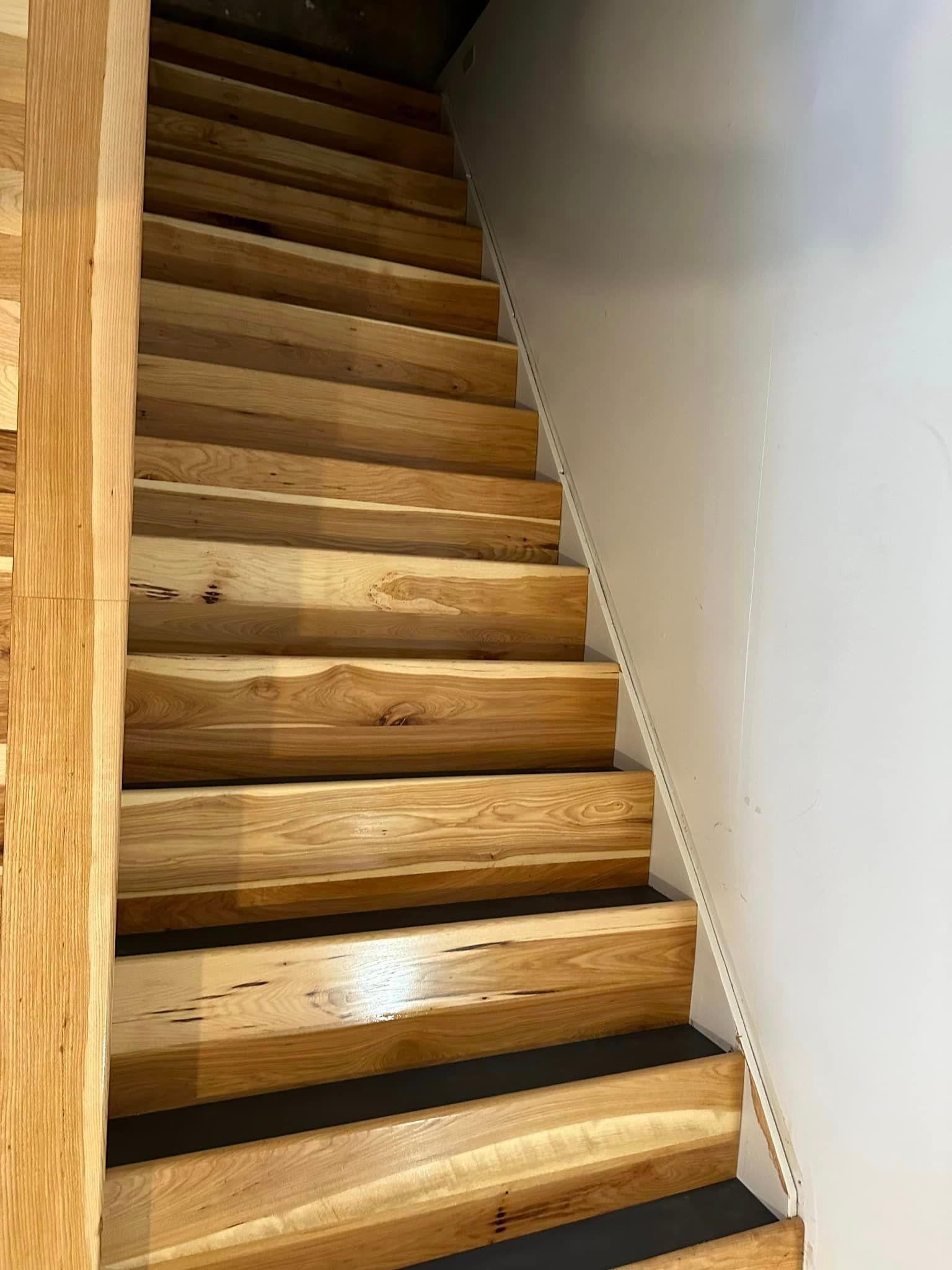 A close up of a wooden staircase in a house.