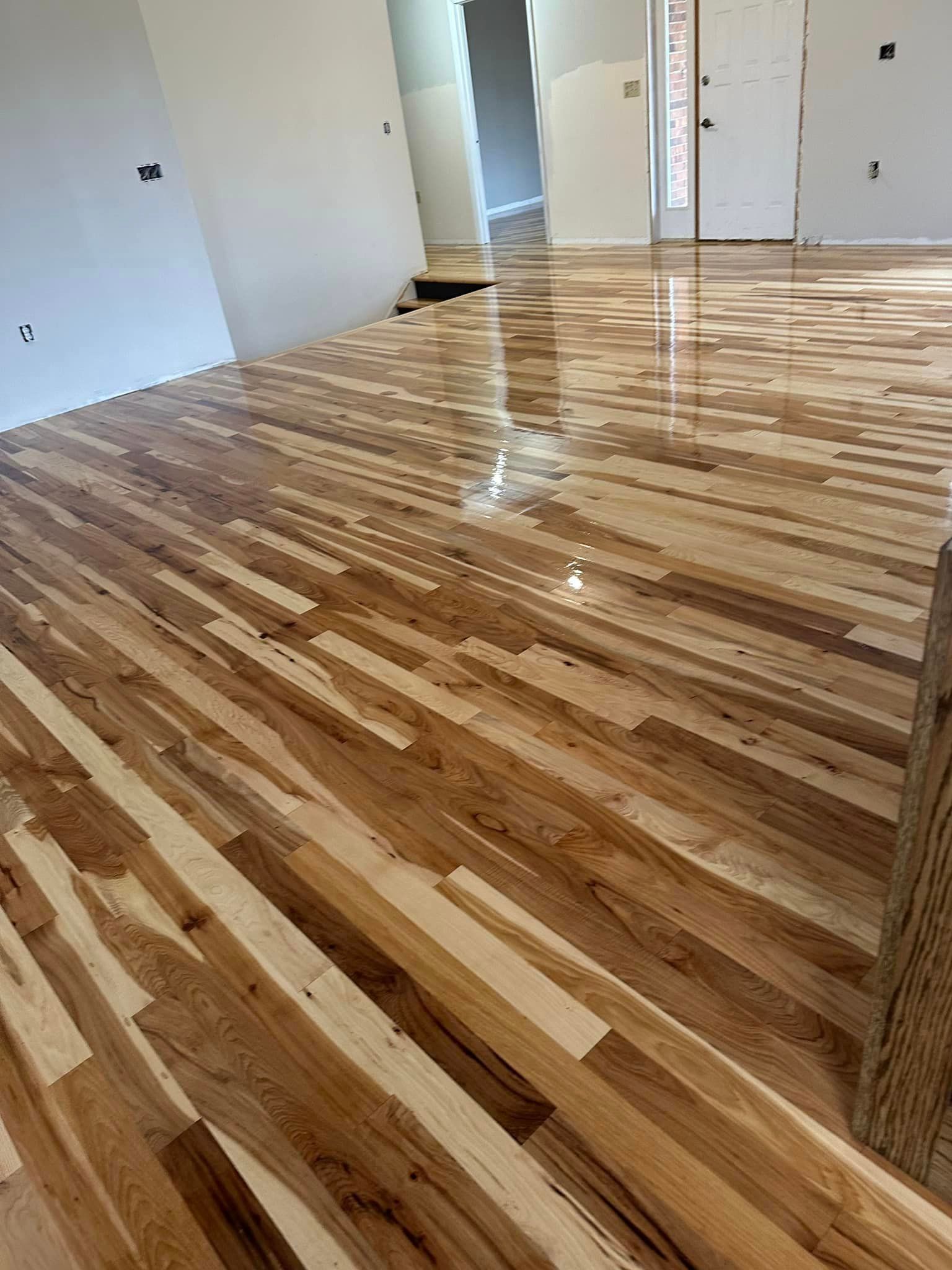 A living room with a wooden floor and white walls.