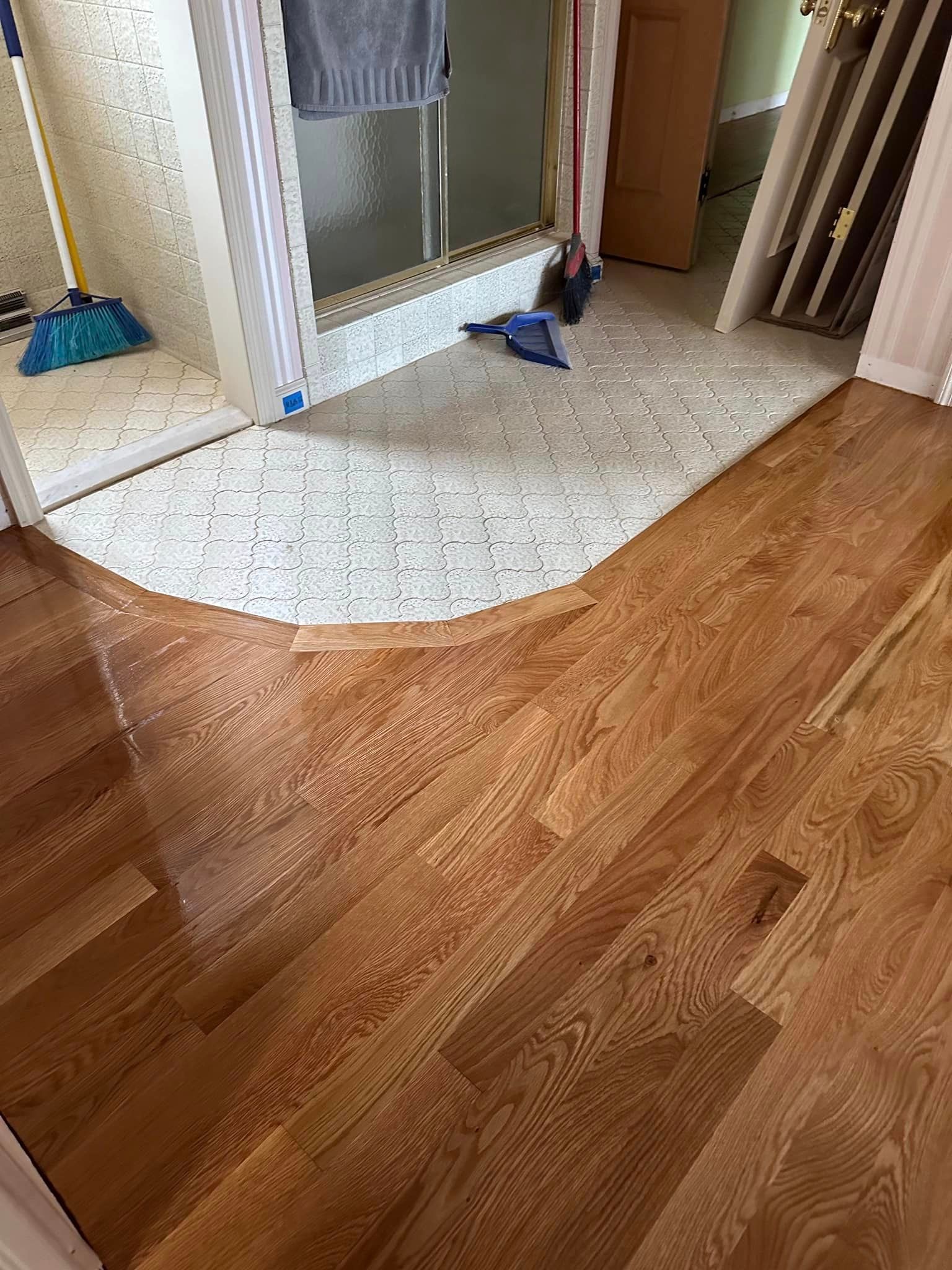 A bathroom with hardwood floors.
