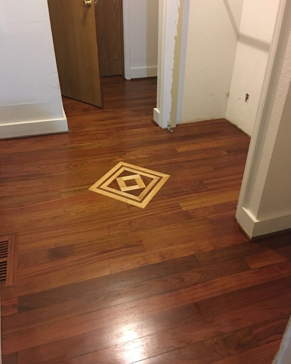 A wooden floor with a square in the middle of it.