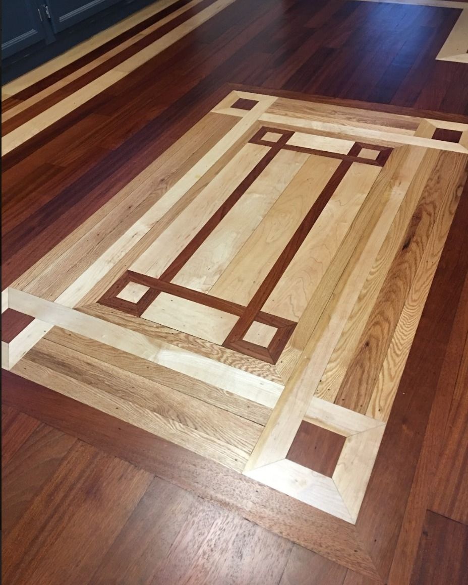 A wooden floor with a geometric design on it