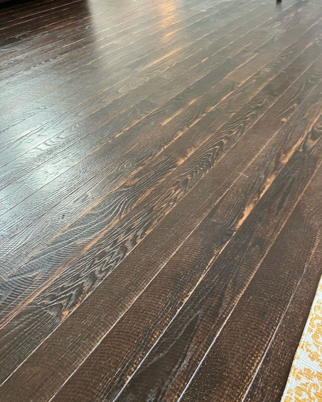 A close up of a wooden floor in a living room.
