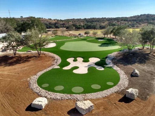 Aerial view of a unique golf green with a whimsical shape.