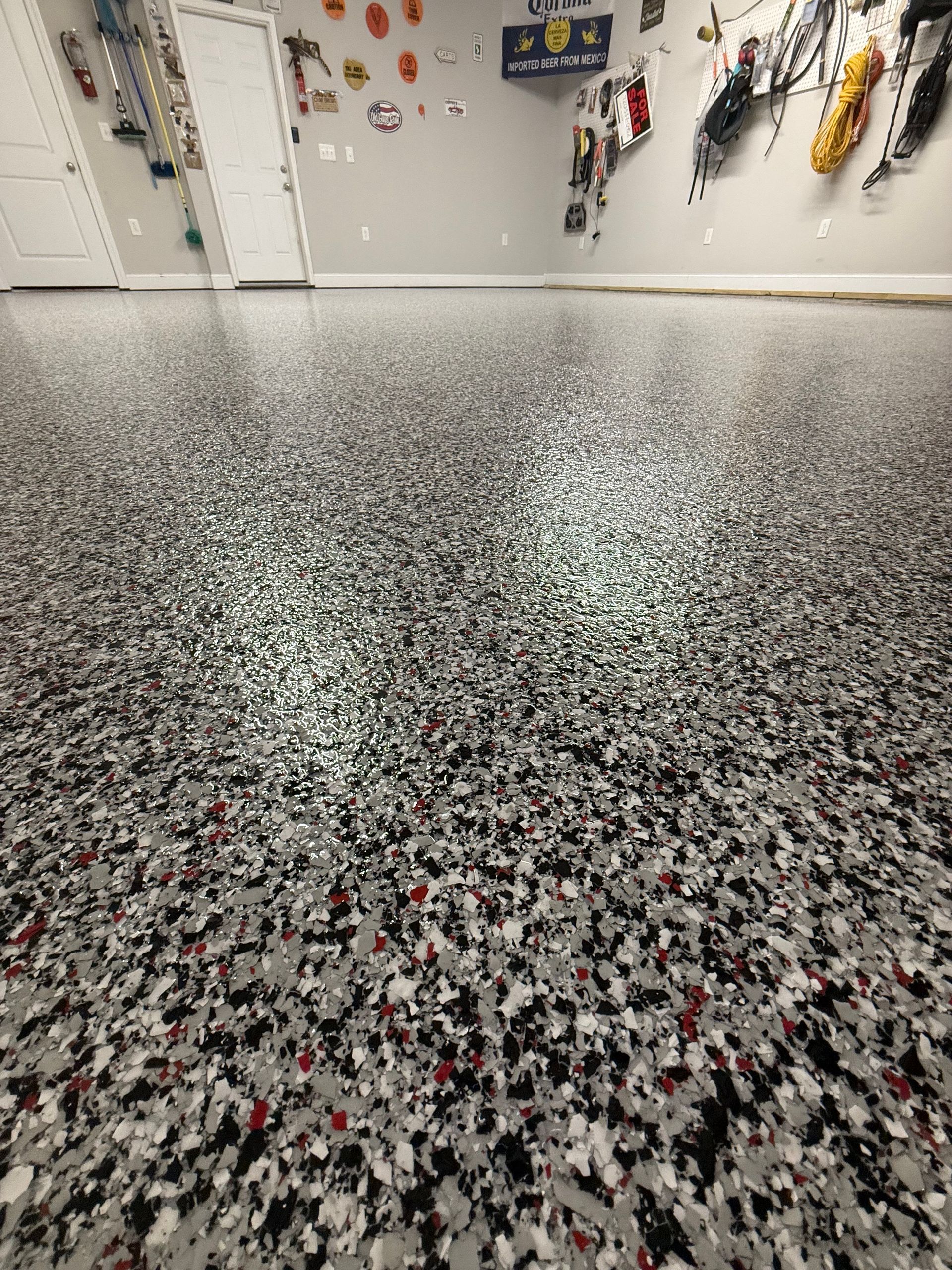 Sparkling speckled floor in a room with white walls and hanging decorations