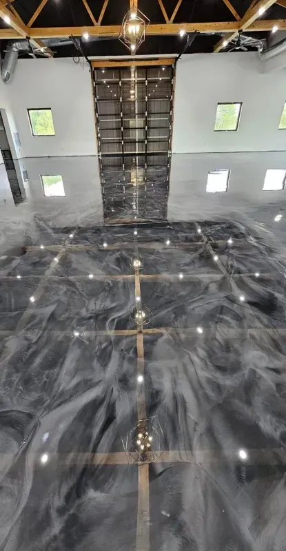 Empty modern interior with glossy black marble floor, white walls, small windows, and exposed wooden ceiling beams
