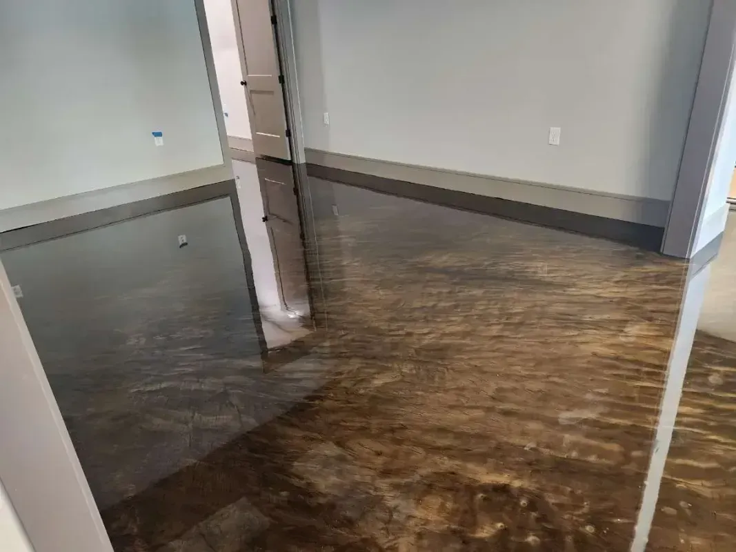 Flooded room with dark water covering the floor and reflecting the walls and doorway.