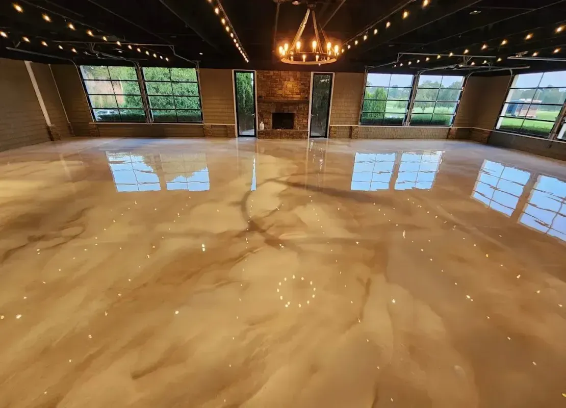 Glossy marble event hall with chandelier lights and large windows reflecting on the polished floor