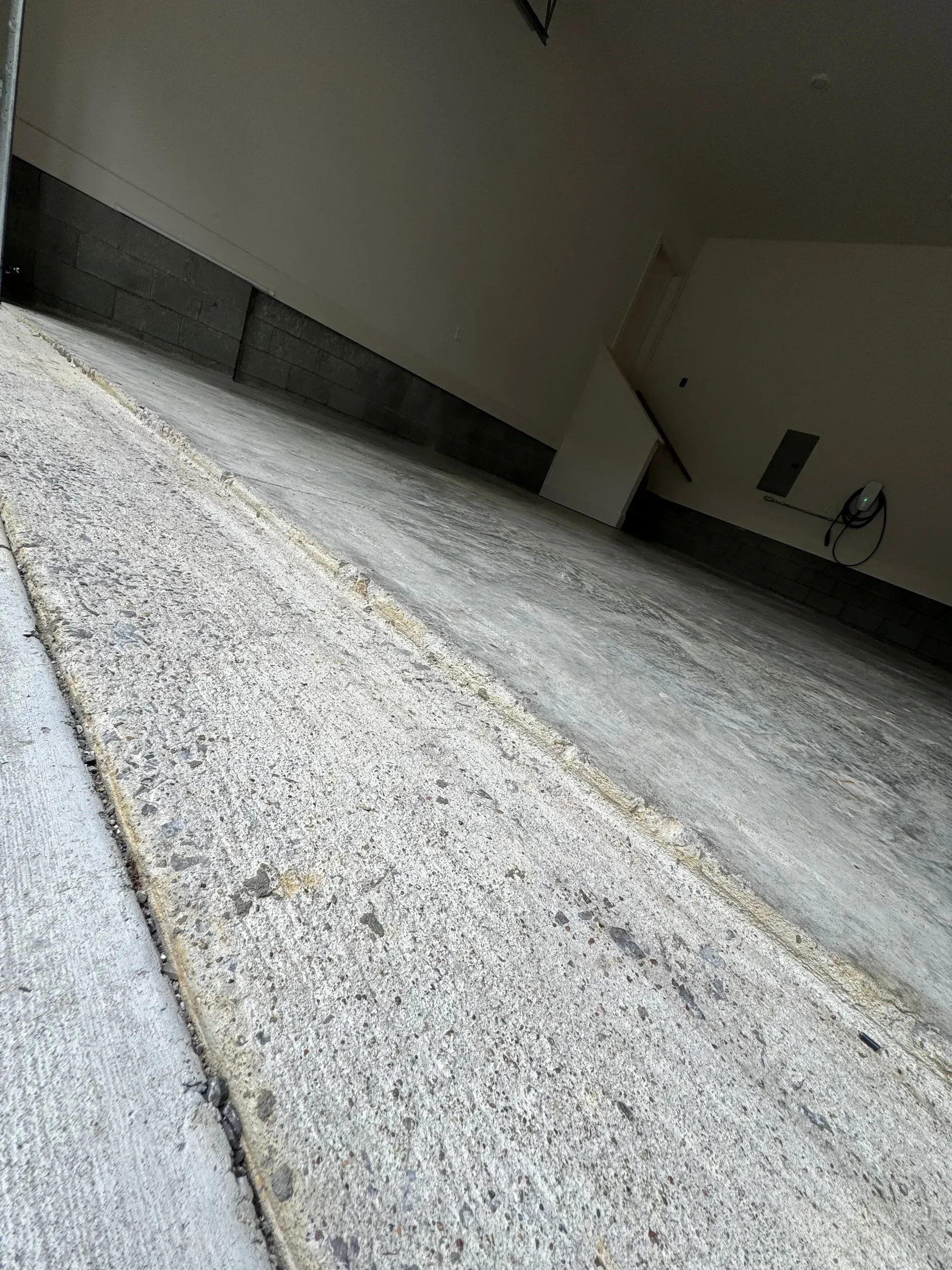 Concrete garage floor with a slight slope.