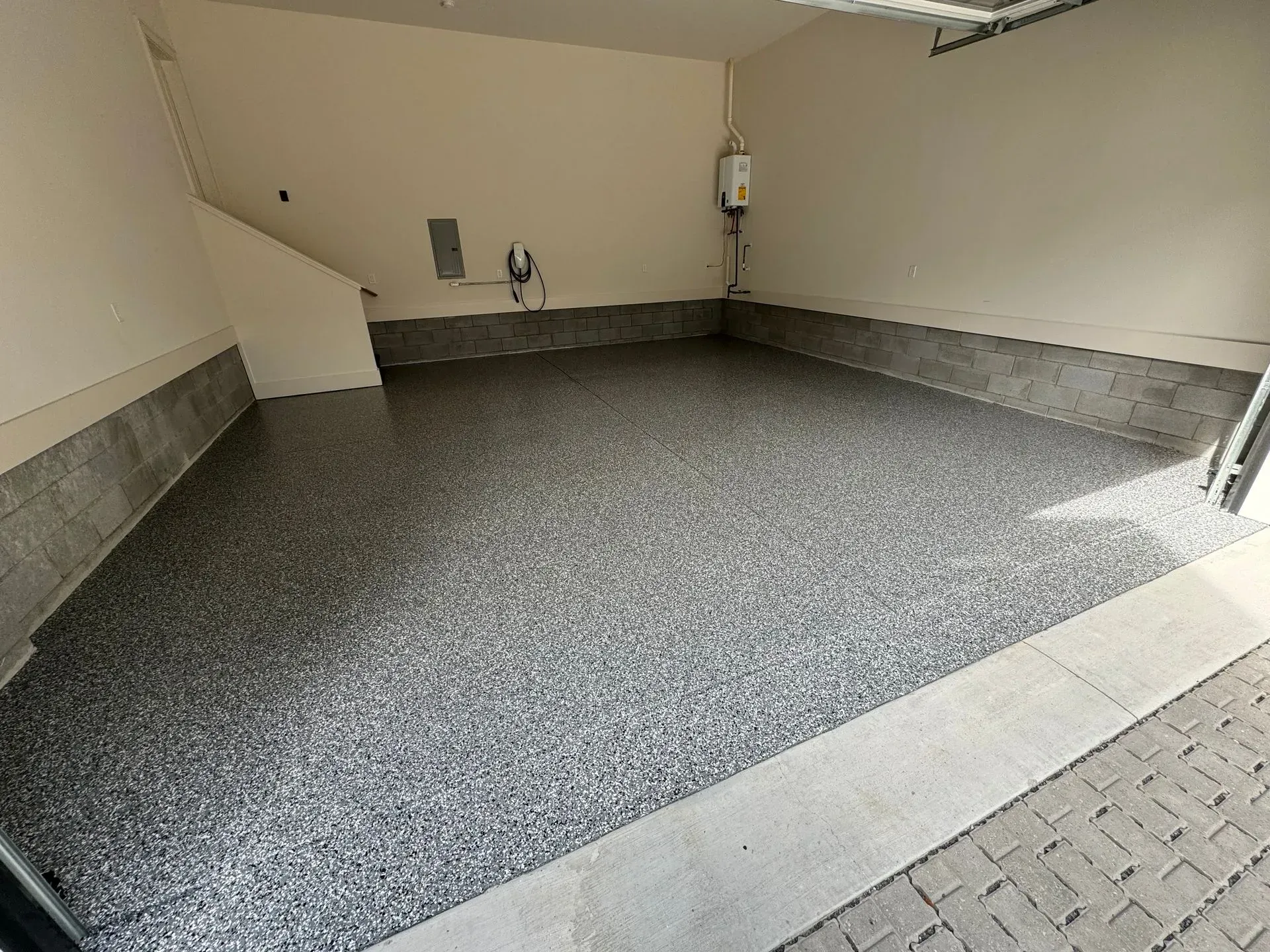 Garage interior with gray speckled epoxy floor.