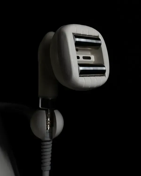Close-up of a gray handheld showerhead against a black background
