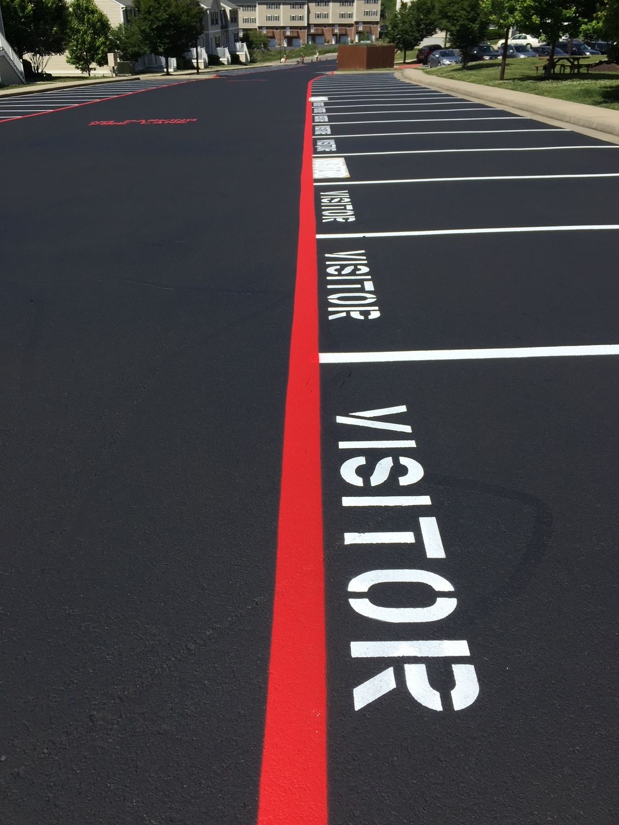 the word visitor is painted on the side of the road