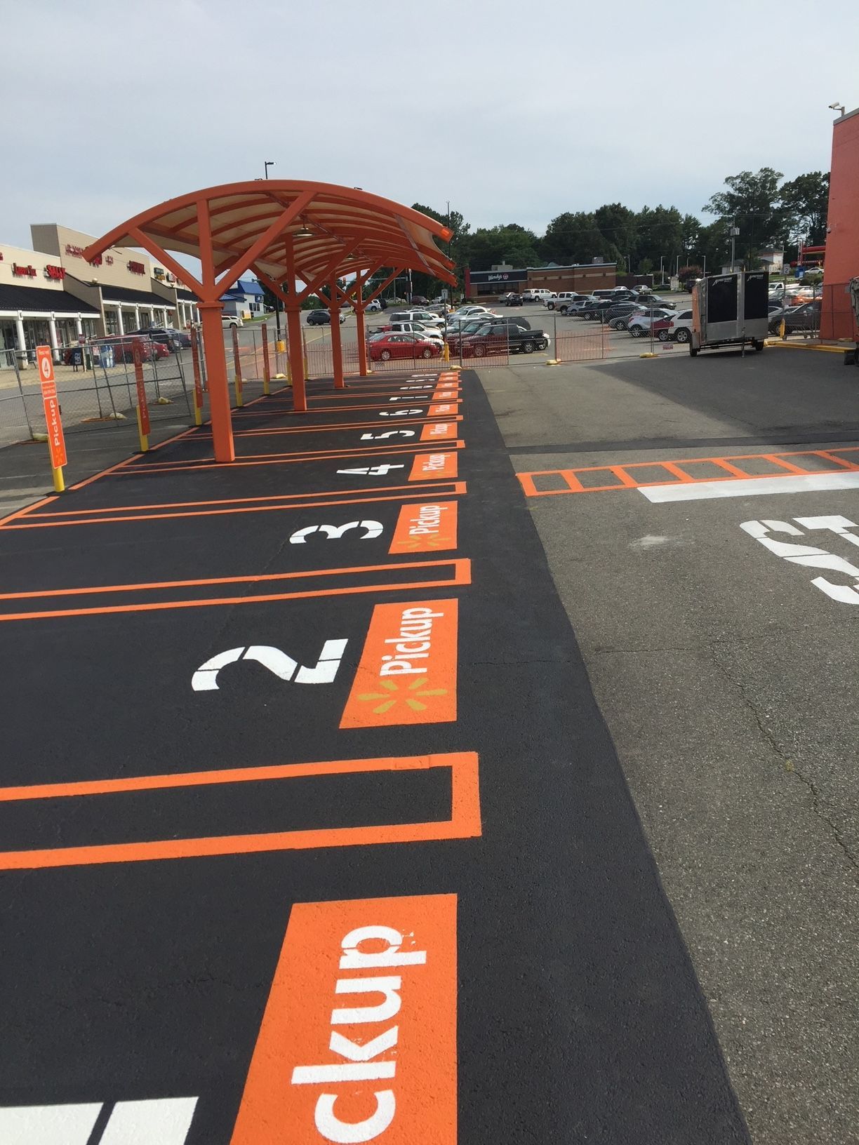 a parking lot with pickup signs painted on it
