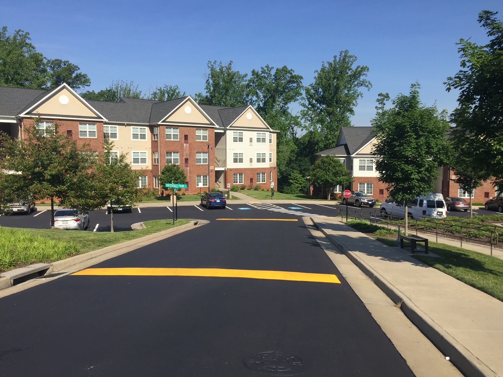 a car is driving down a street in front of a building