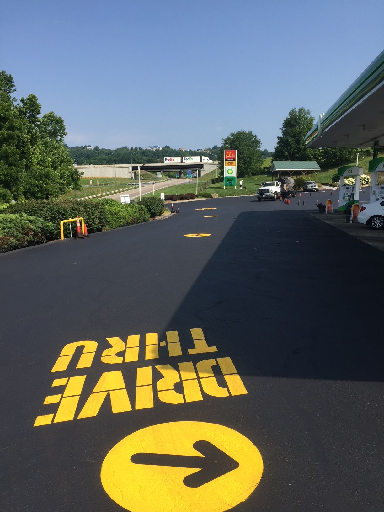 a drive thru at a gas station with a yellow arrow pointing to the right