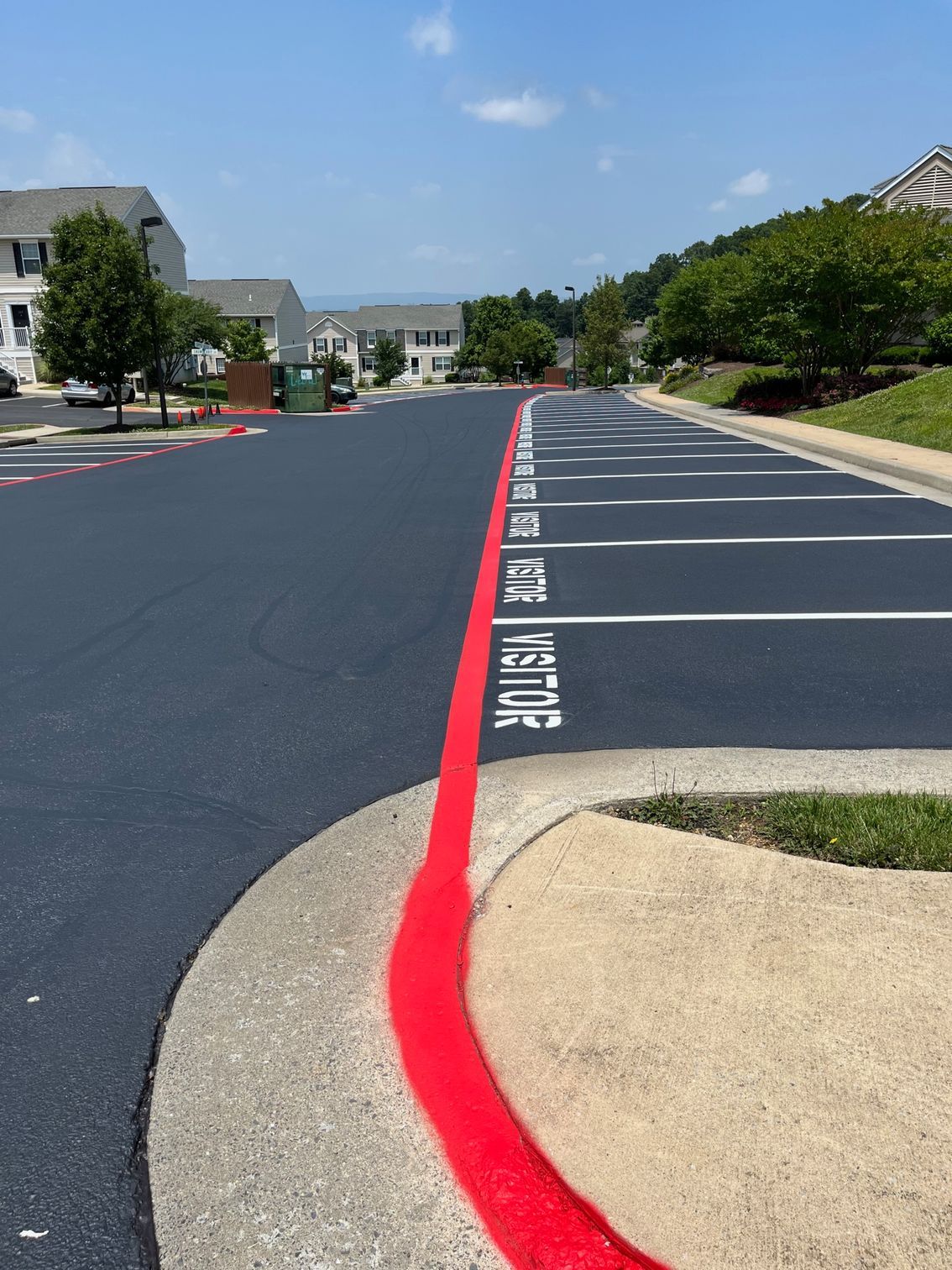 a parking lot with a red line that says visitor