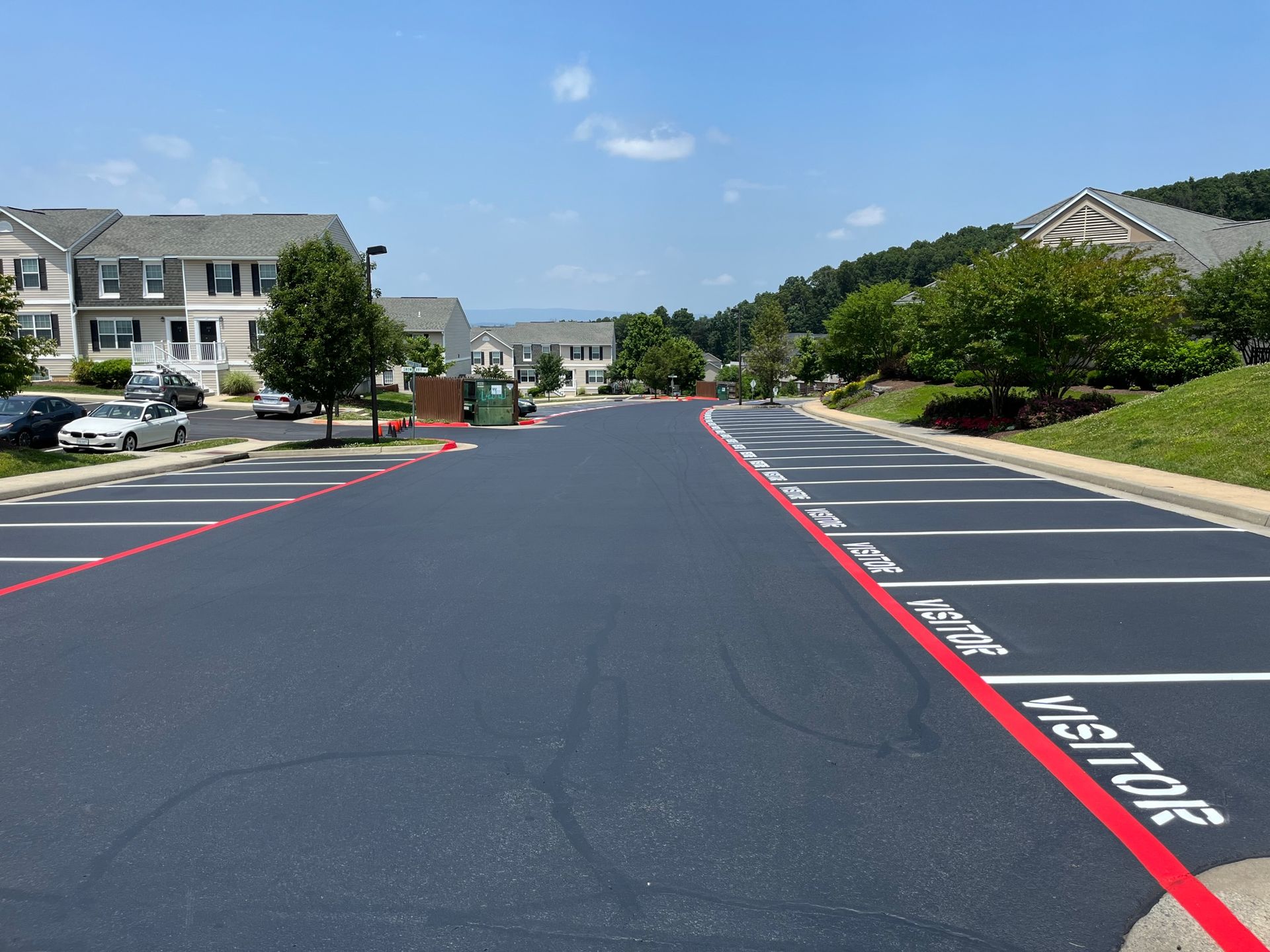 parking lot with a red line that says visitor