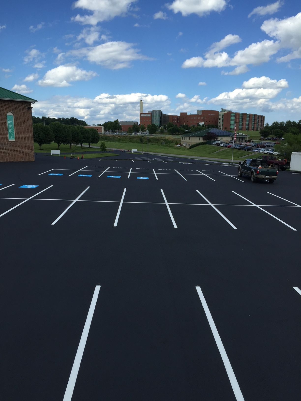 a parking lot with a brick building in the background