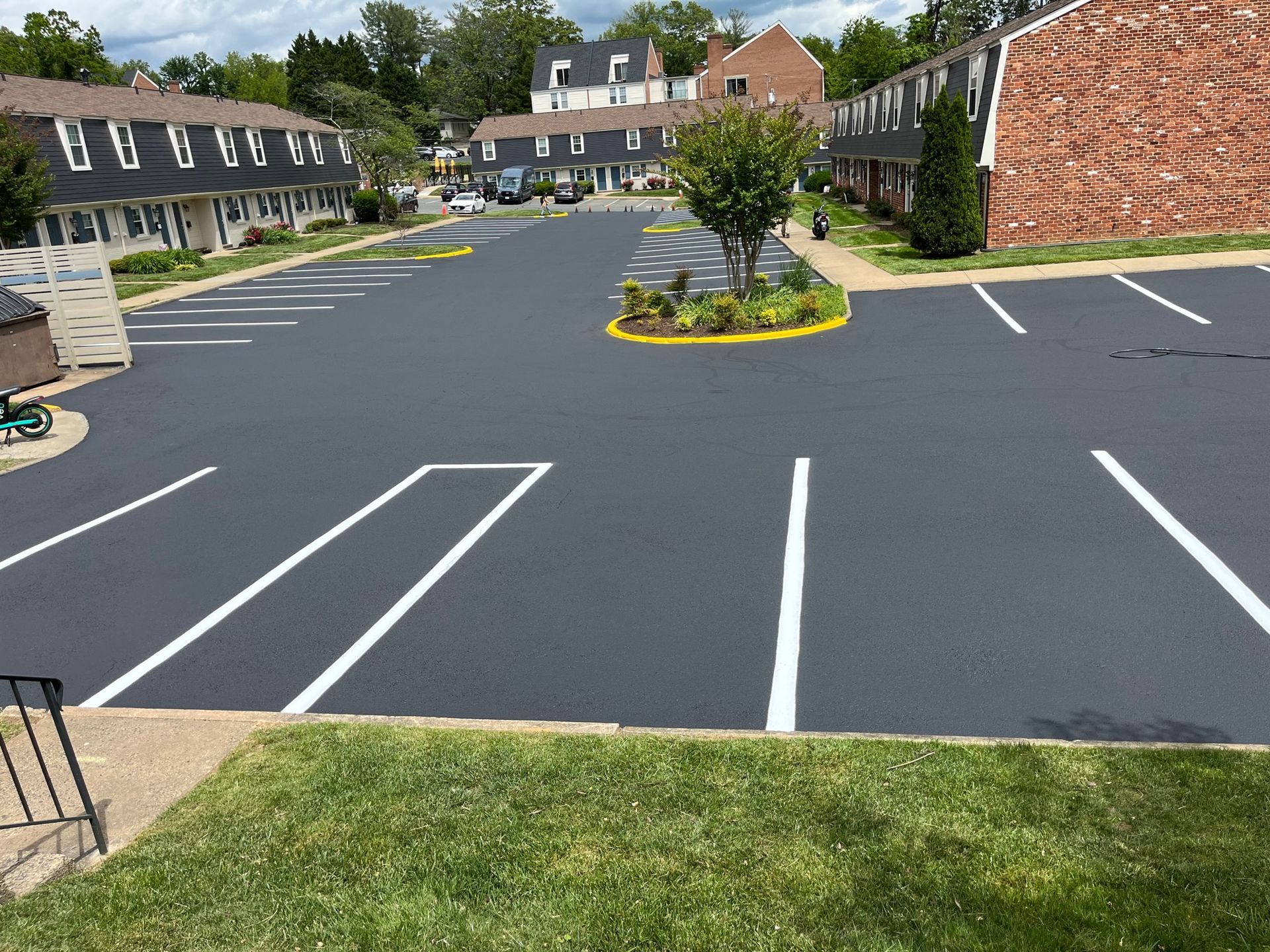 a parking lot with a brick building in the background