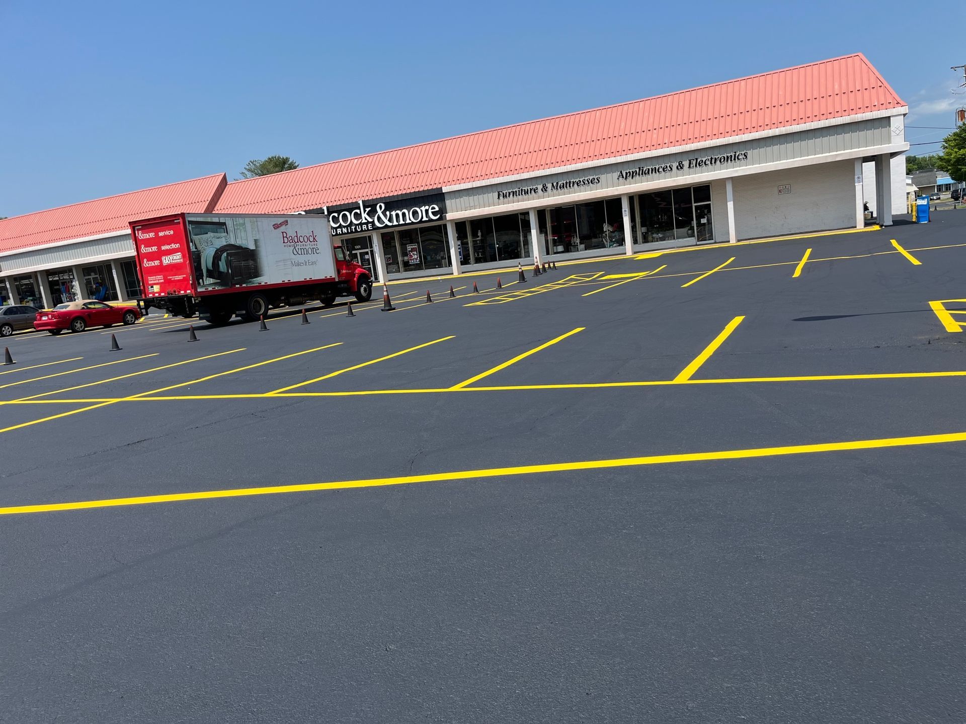 a red truck is parked in front of a store called lock & more