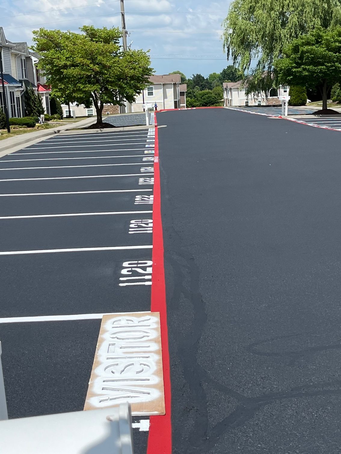 the word visitor is painted on the side of the road