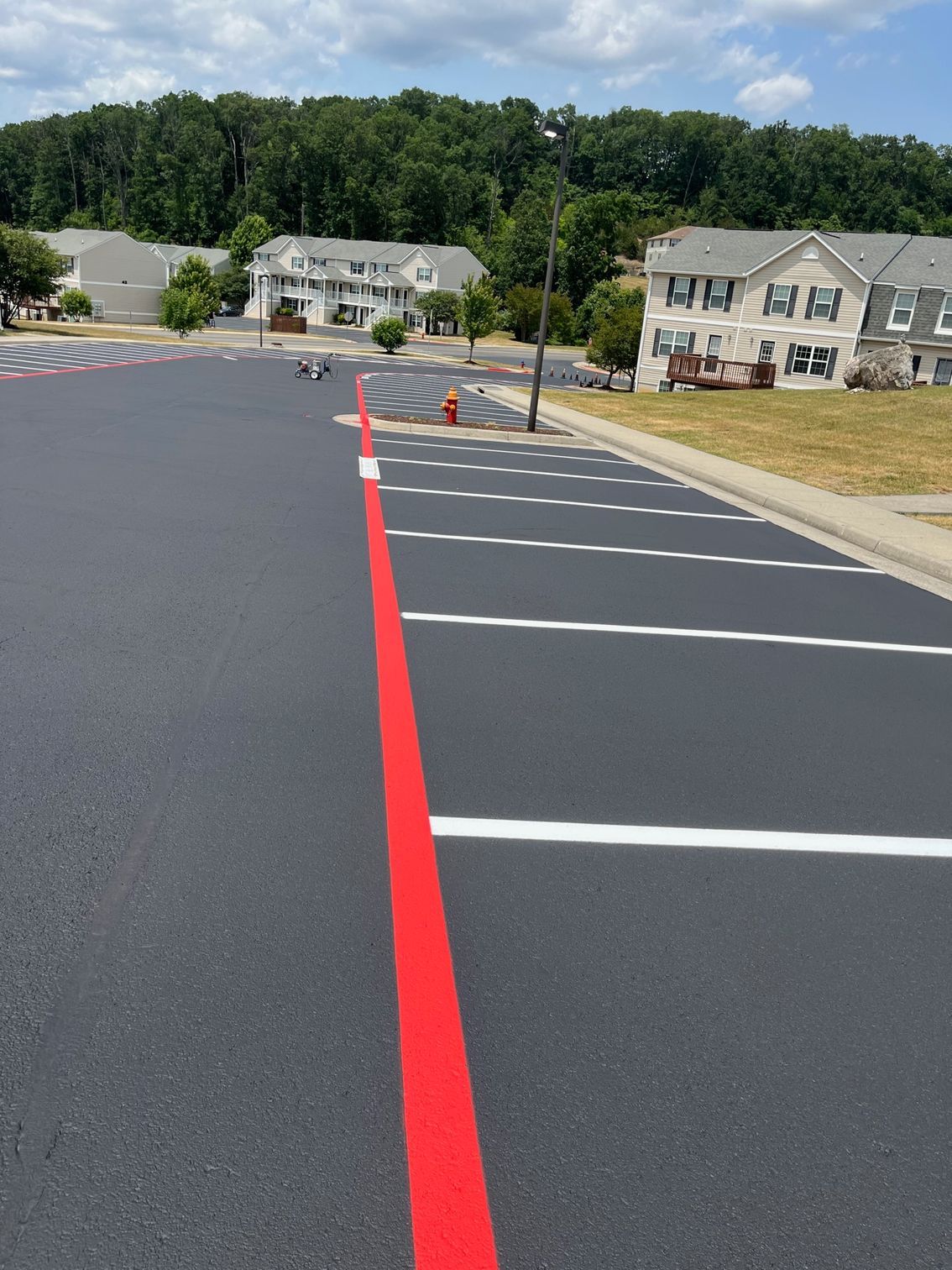 a red line is painted on the side of a parking lot