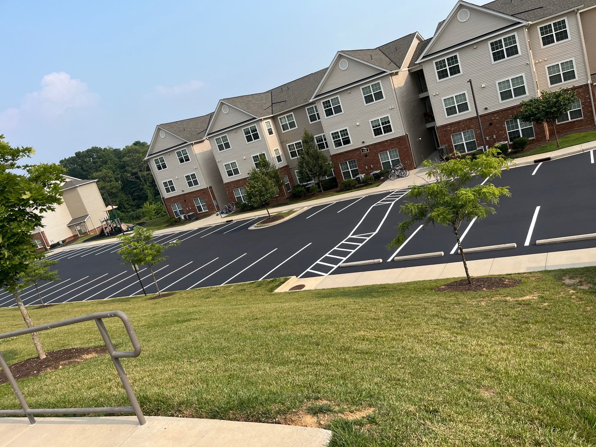 a large apartment building with a parking lot in front of it
